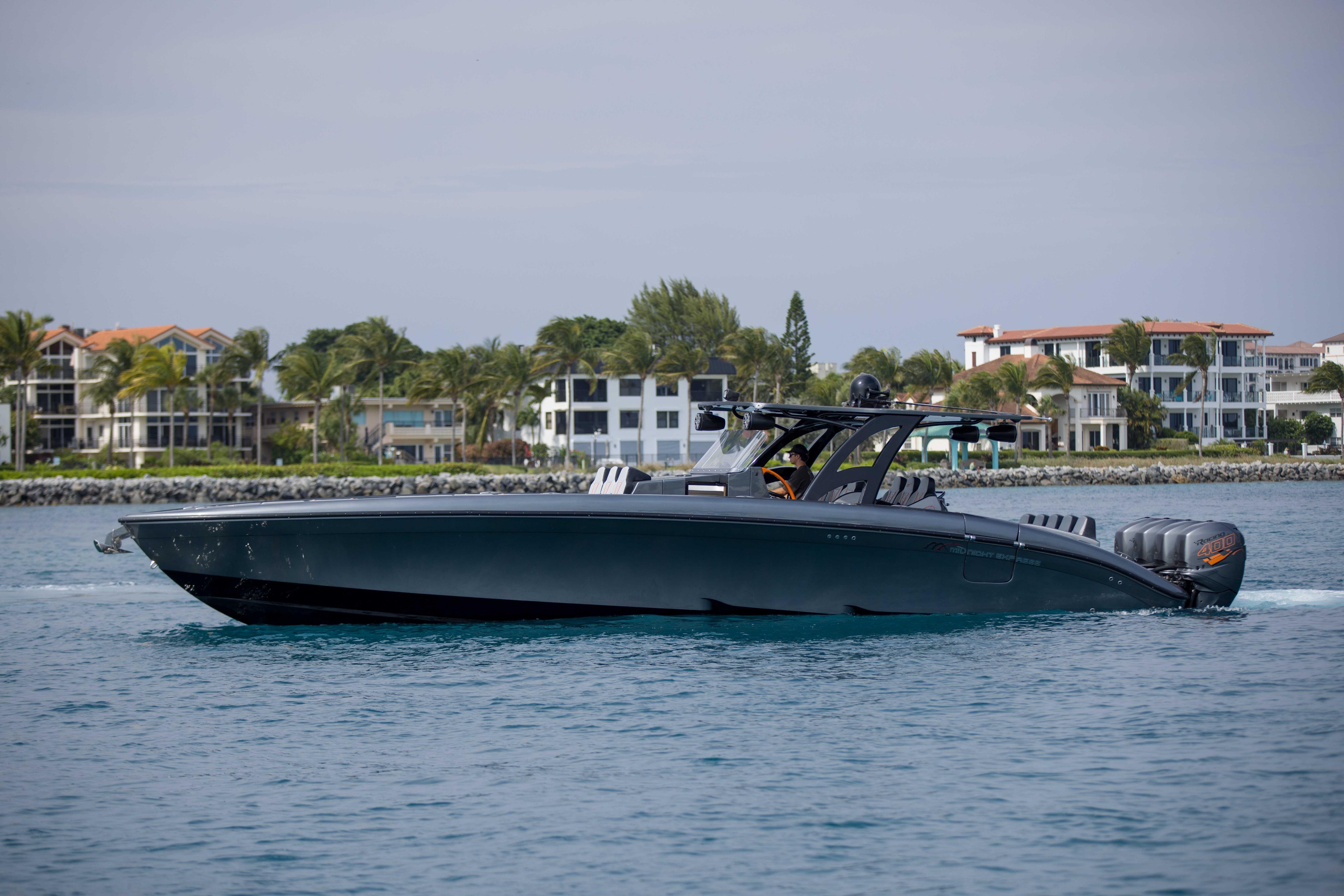 2019 Midnight Express 43 Open boat cruising near luxury waterfront homes.