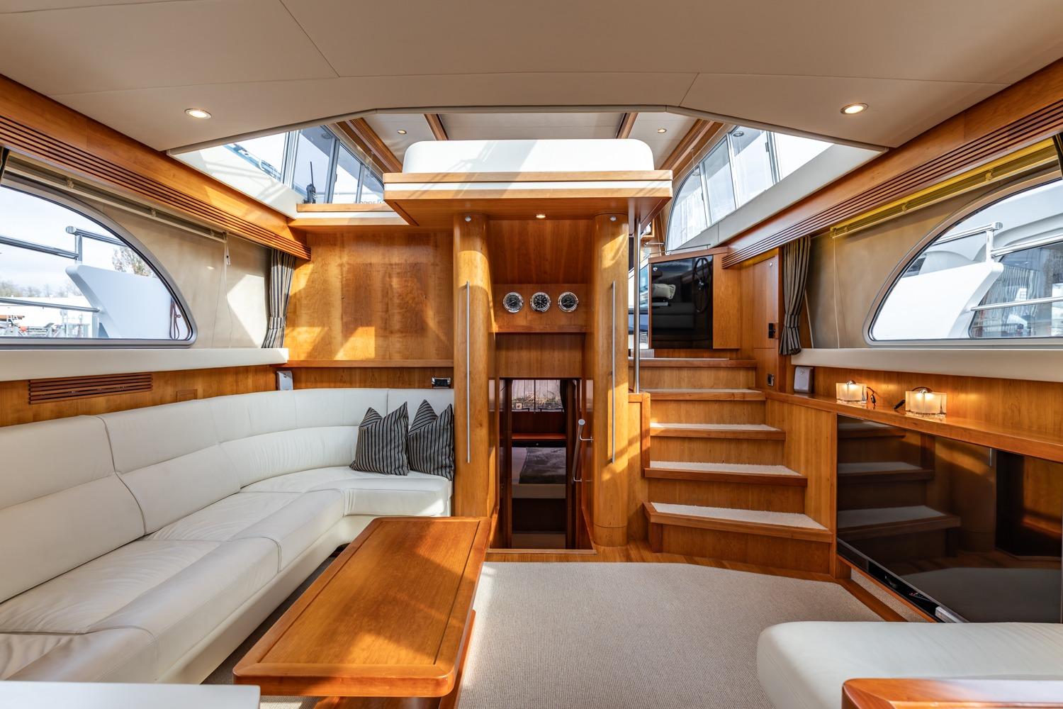Luxurious interior of 2005 Van der Valk Continental 1900 yacht with elegant wood finishes.