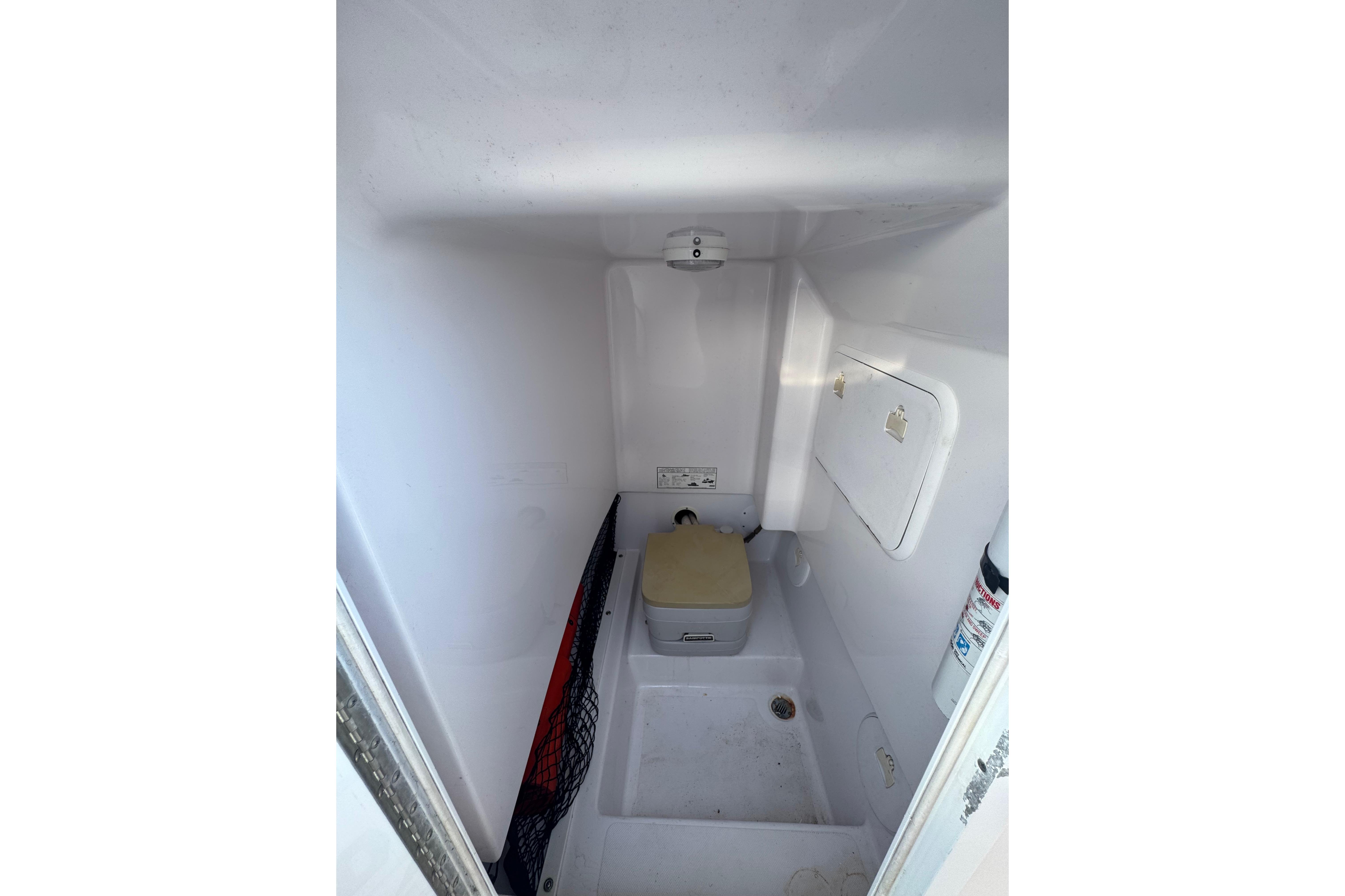 2002 Pro-Line 23 Sport boat interior with compact marine toilet.