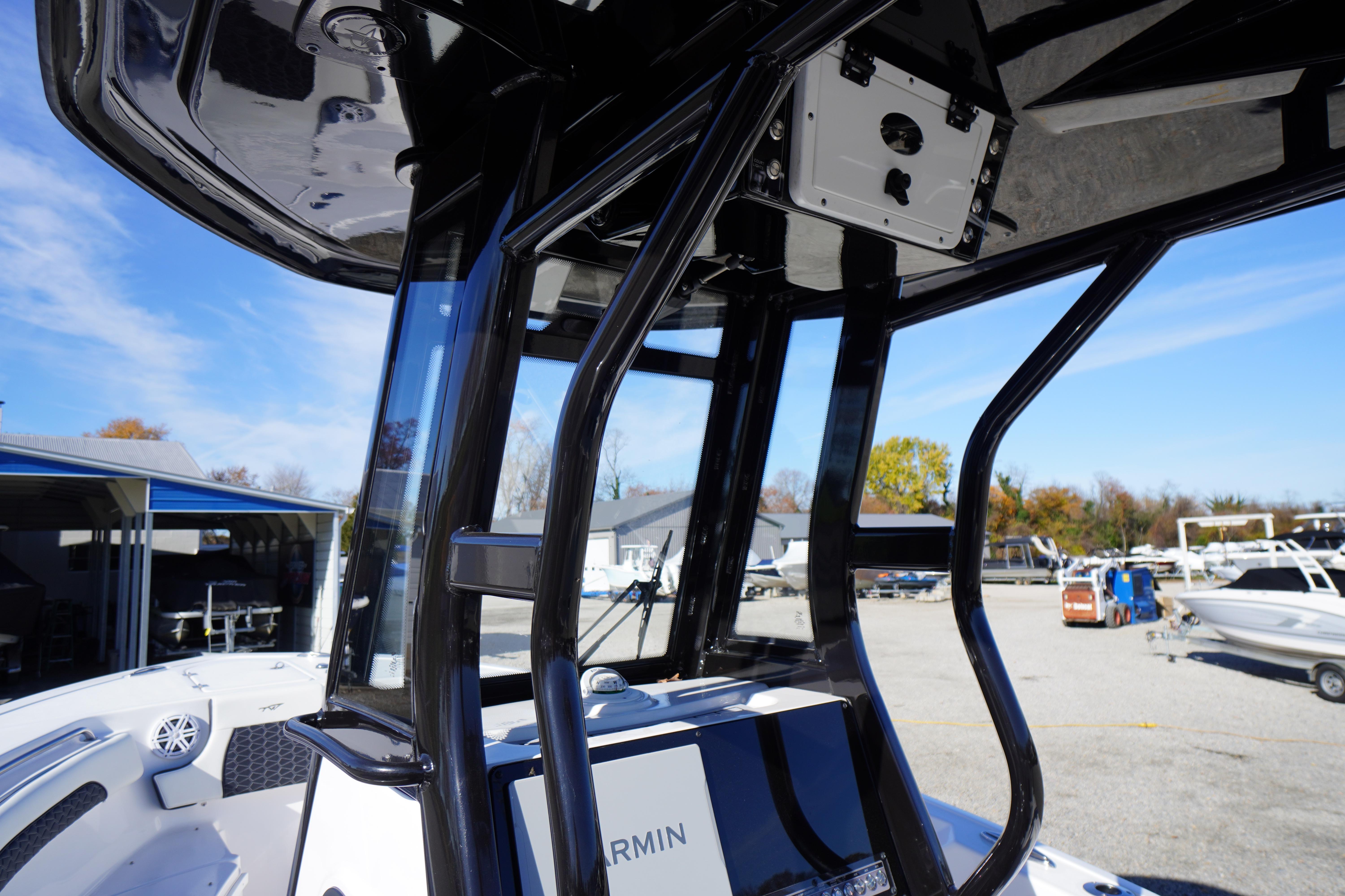 2024 Tidewater 232 SS boat with sleek black T-top and advanced Garmin electronics.