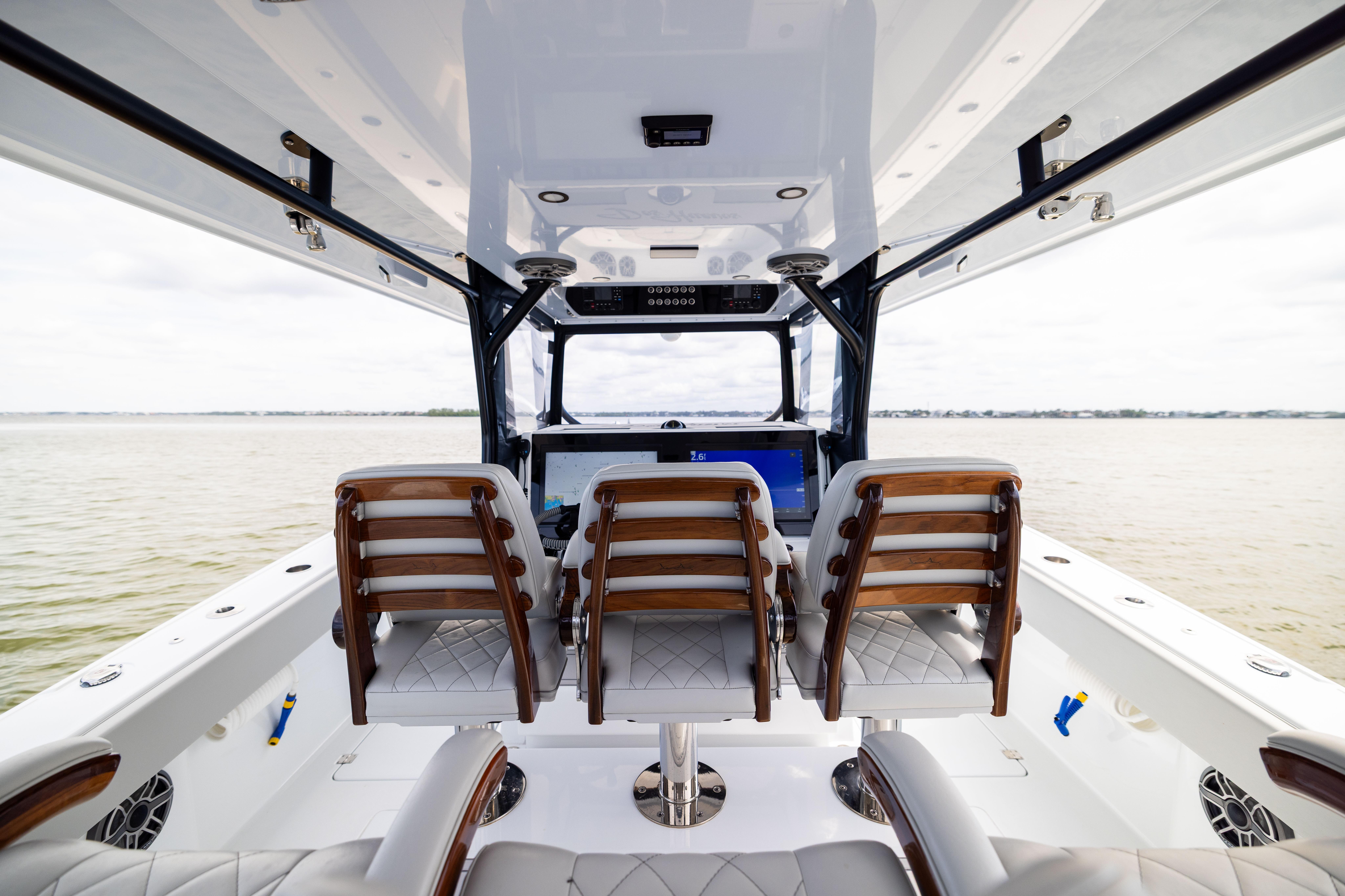 Interior view of 2025 Freeman 42 LR boat with luxurious seating and helm.