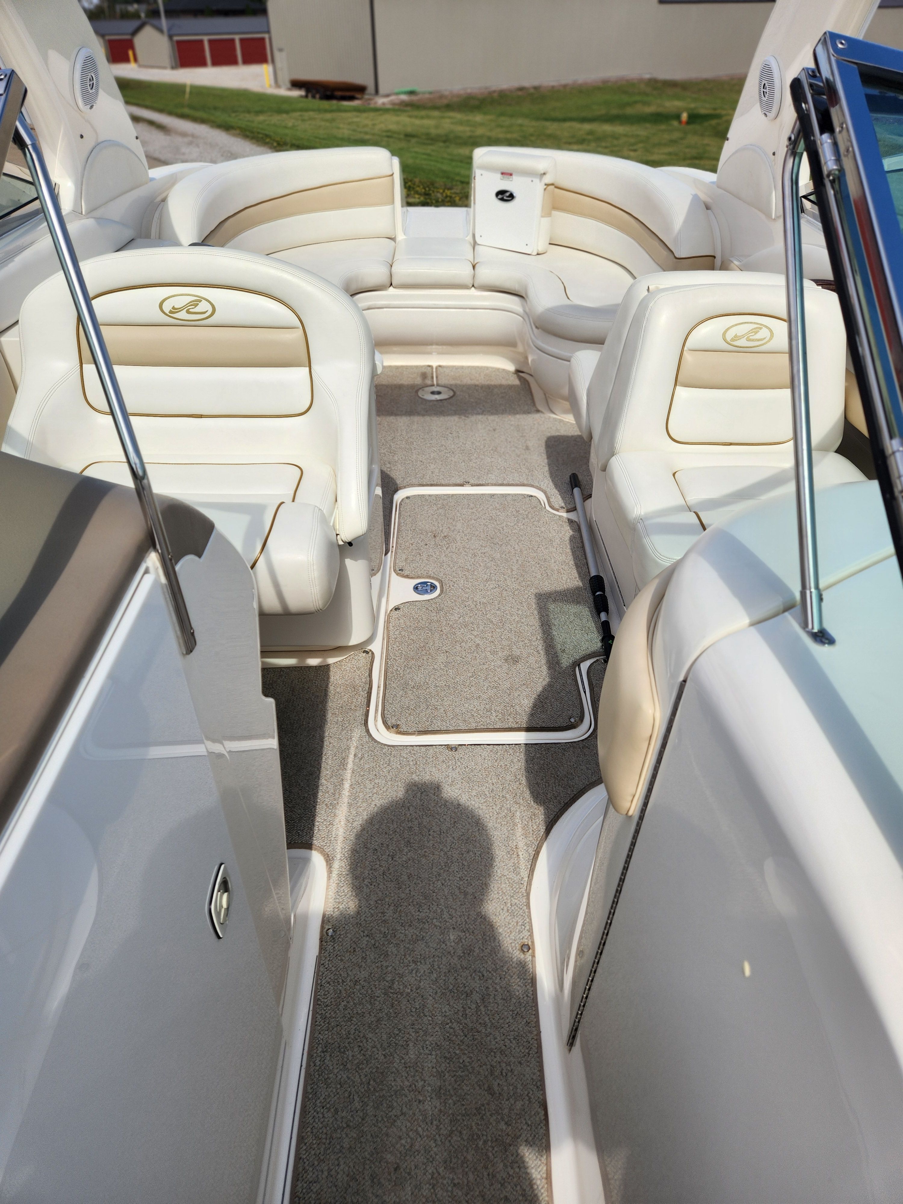 Interior view of a Sea Ray 290 BR boat with beige seating and carpeted floor.