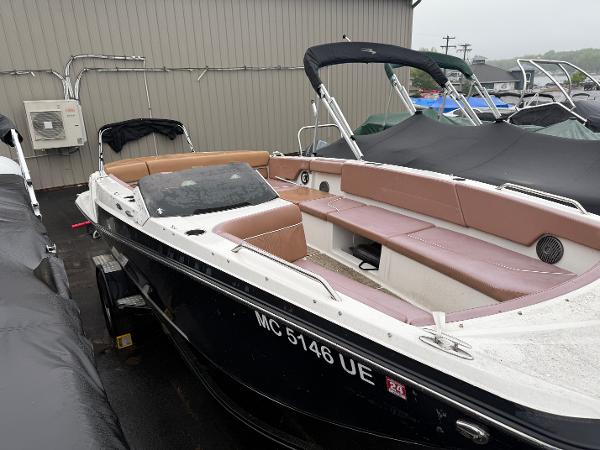 2017 Glastron 205 boat with tan seating, docked outdoors.