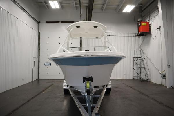 2025 Sea Fox 228 Traveler boat in a spacious indoor showroom.