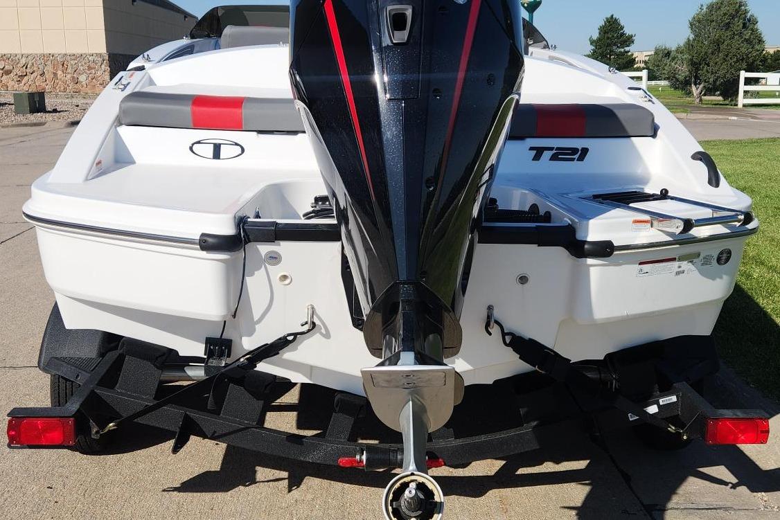 2026 Tahoe T21 boat rear view with outboard motor on trailer.