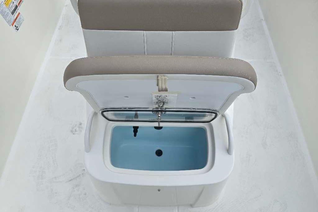 2026 Mako Pro Skiff 19 CC boat seat with built-in storage compartment.