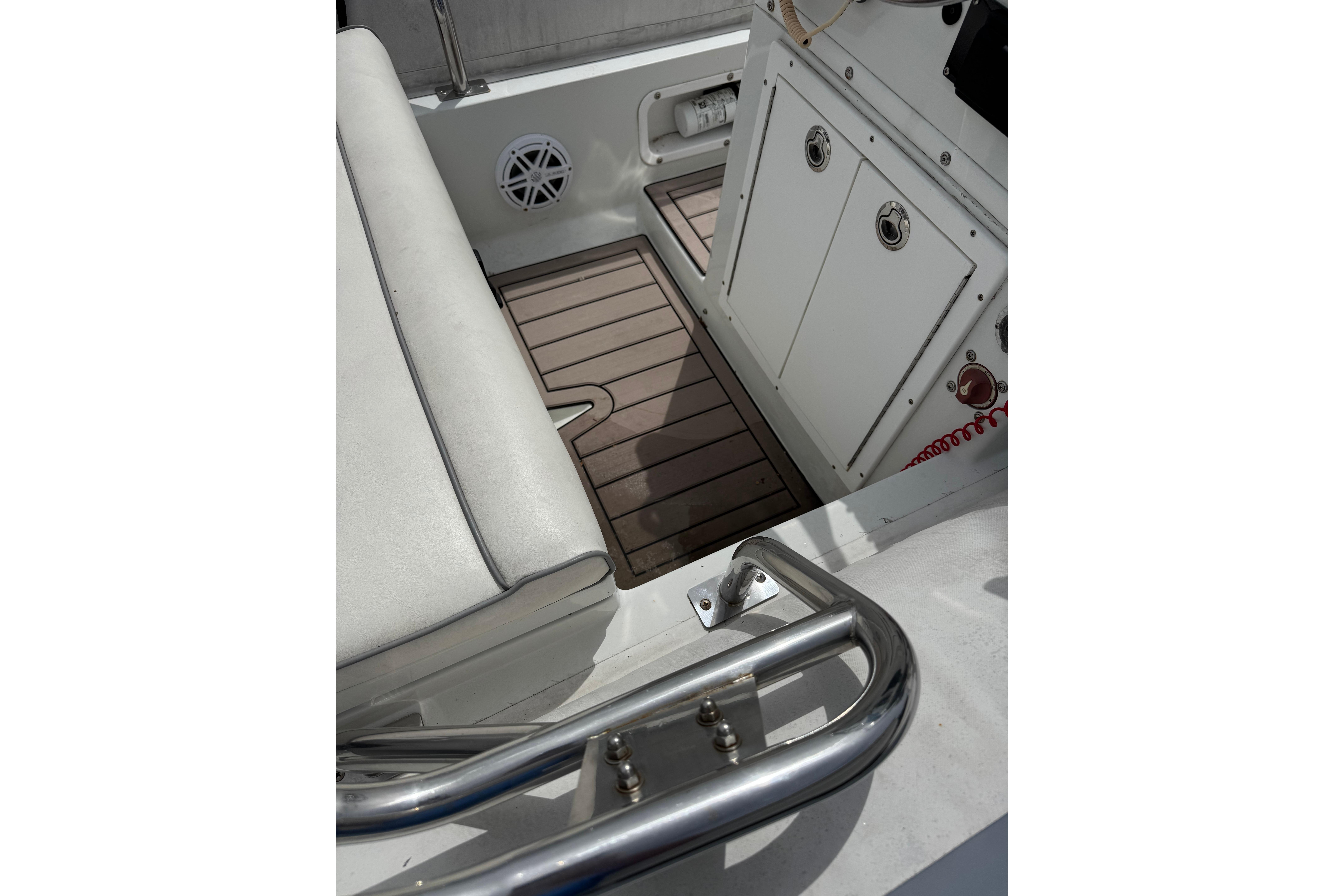 Interior of a 2002 Novurania 17 boat, featuring seating and storage compartments.