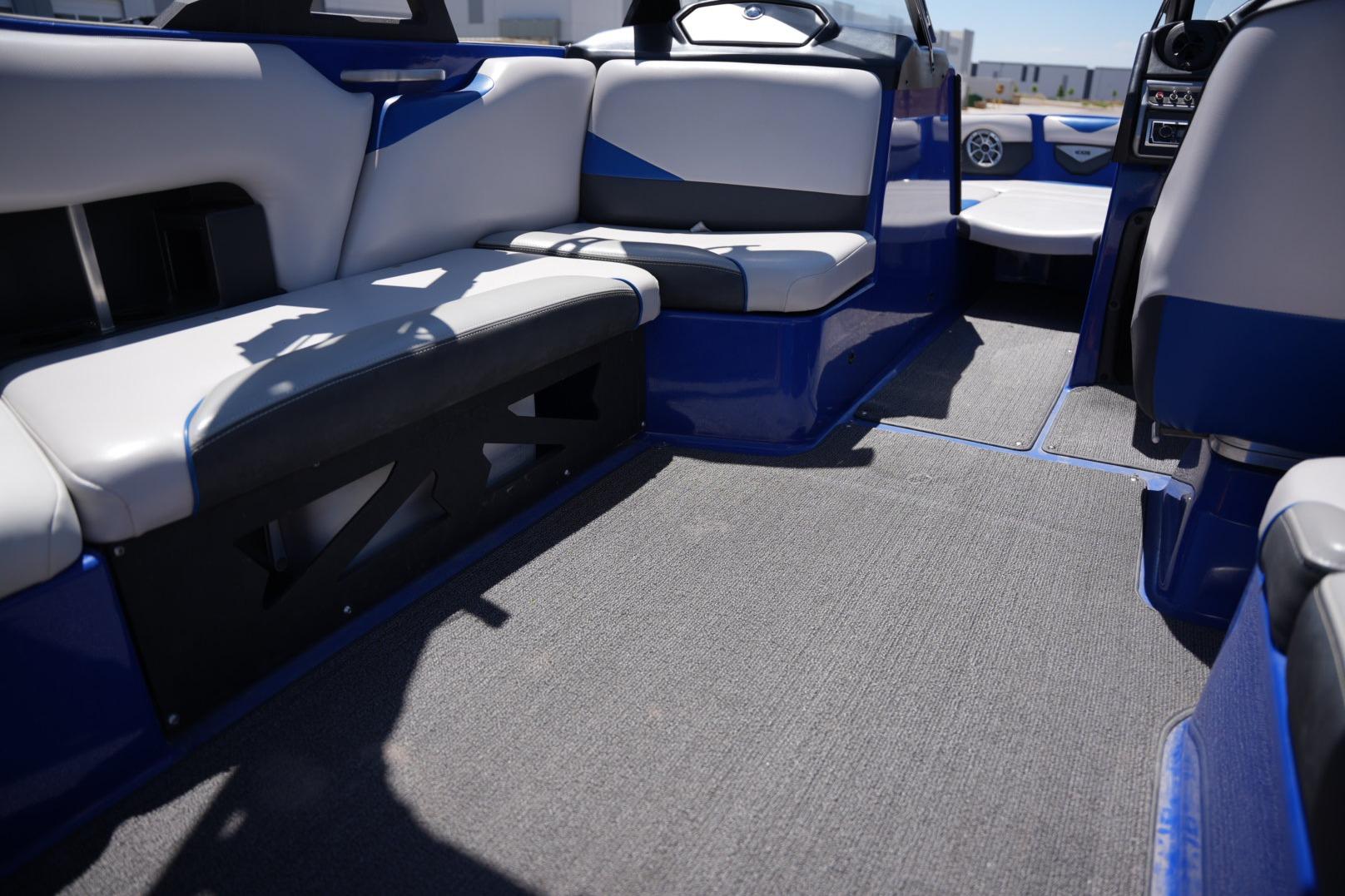 Interior of a 2015 Axis A24 boat with blue and gray seating.