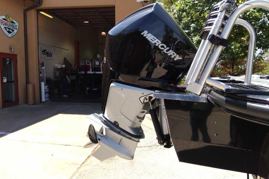 2026 Regency 230 DL with Mercury outboard motor at a service center.