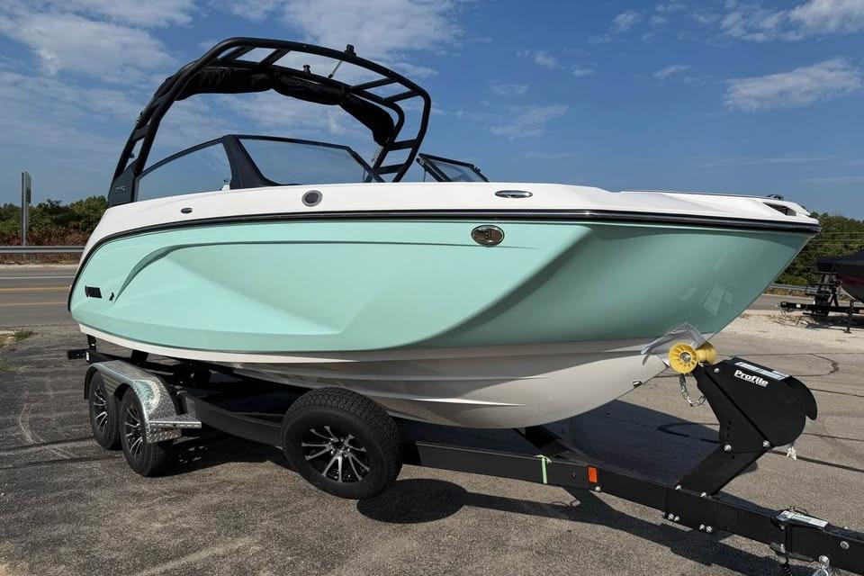 2026 Yamaha Boats 222S on trailer, mint green hull, parked outdoors.