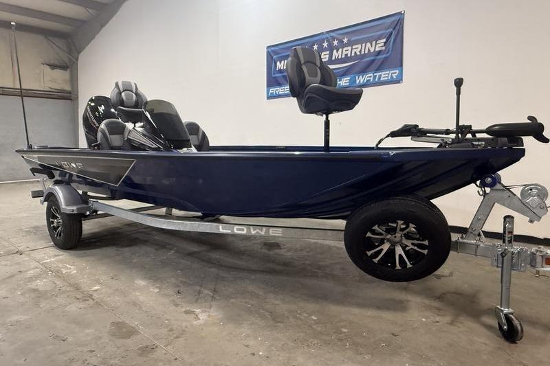 2026 Lowe Stinger 175C boat on trailer in showroom setting.