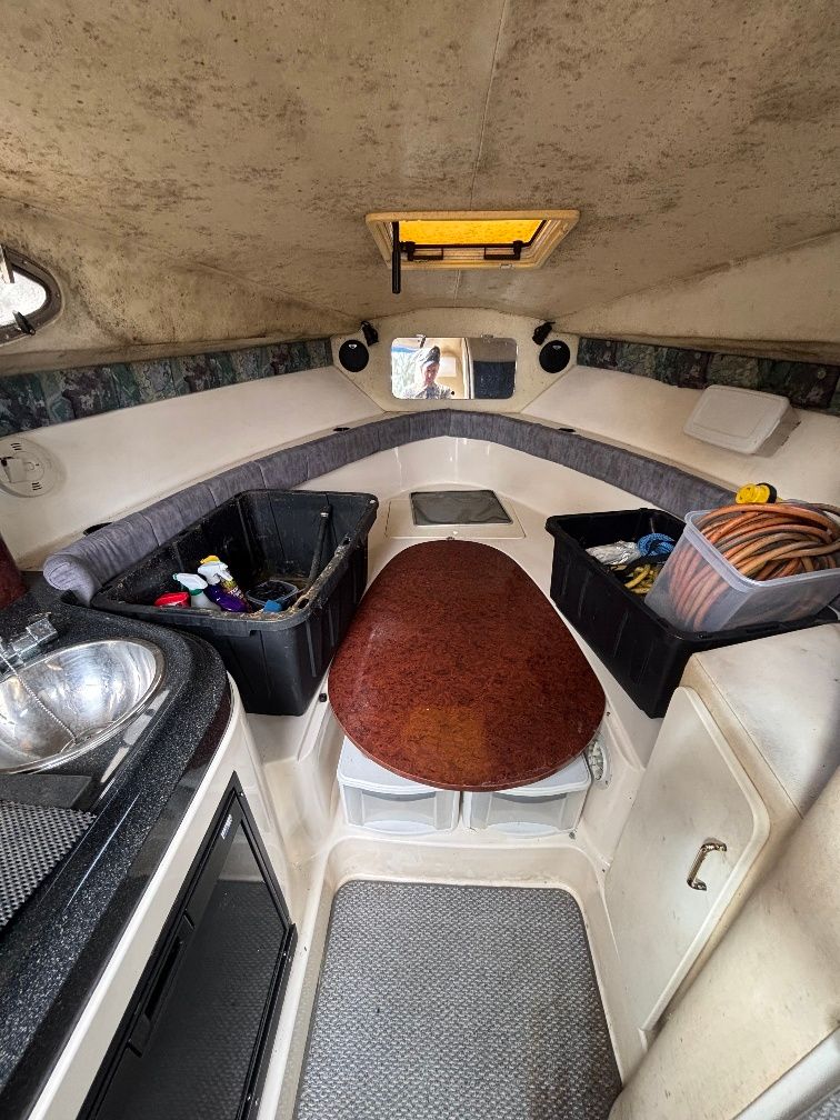 Interior of a 1997 Donzi 275LXC with storage and sink.