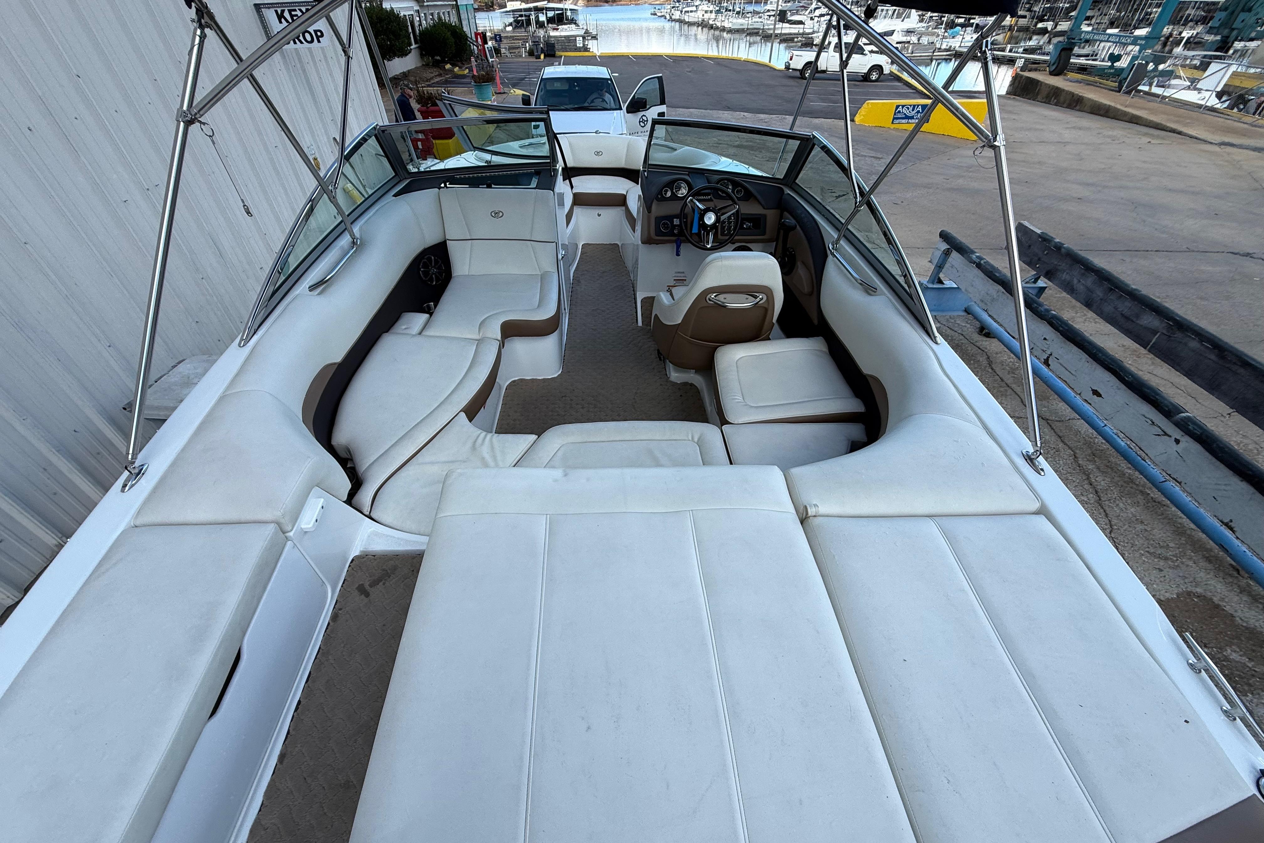 2015 Cobalt 200 boat interior with white seating and steering wheel, docked at marina.