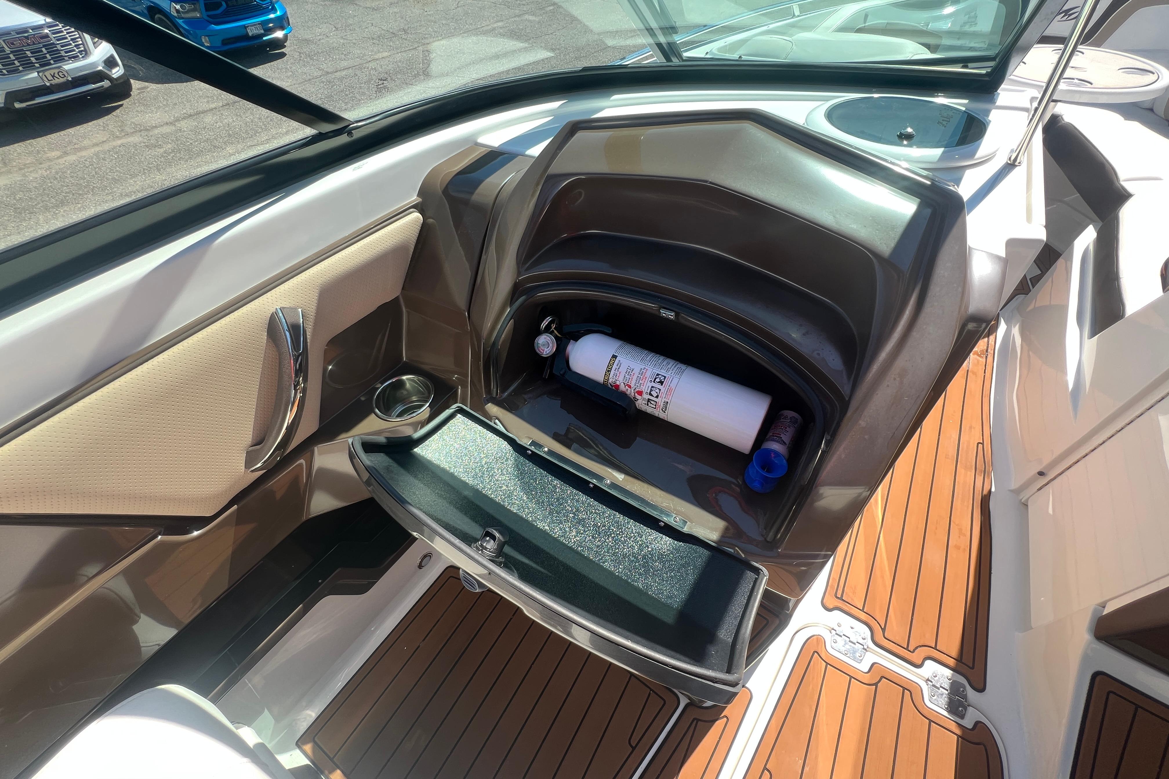 2017 Monterey 298SS Super Sport boat interior with storage compartment and fire extinguisher.