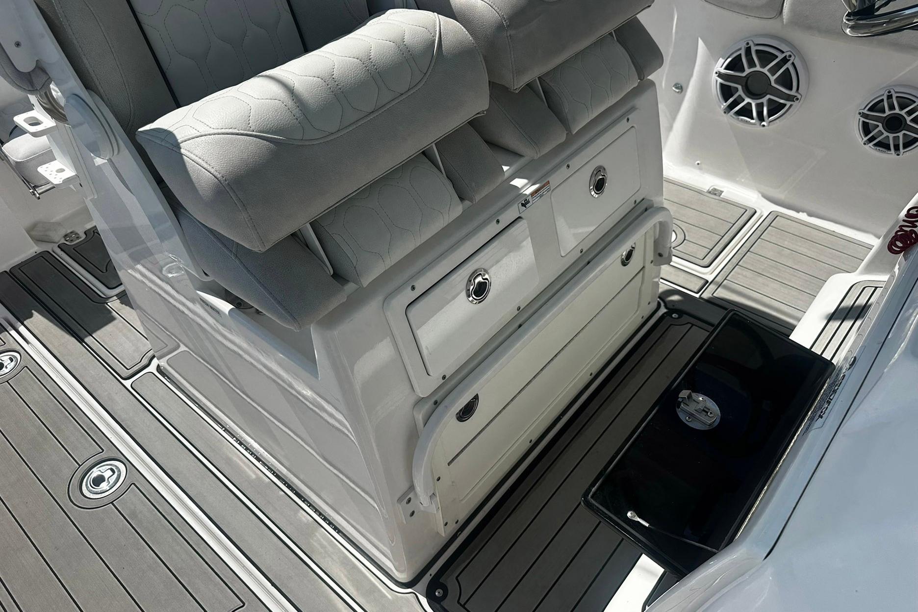 Interior of 2002 Sea Fox 228 Commander boat with cushioned seating and storage compartments.
