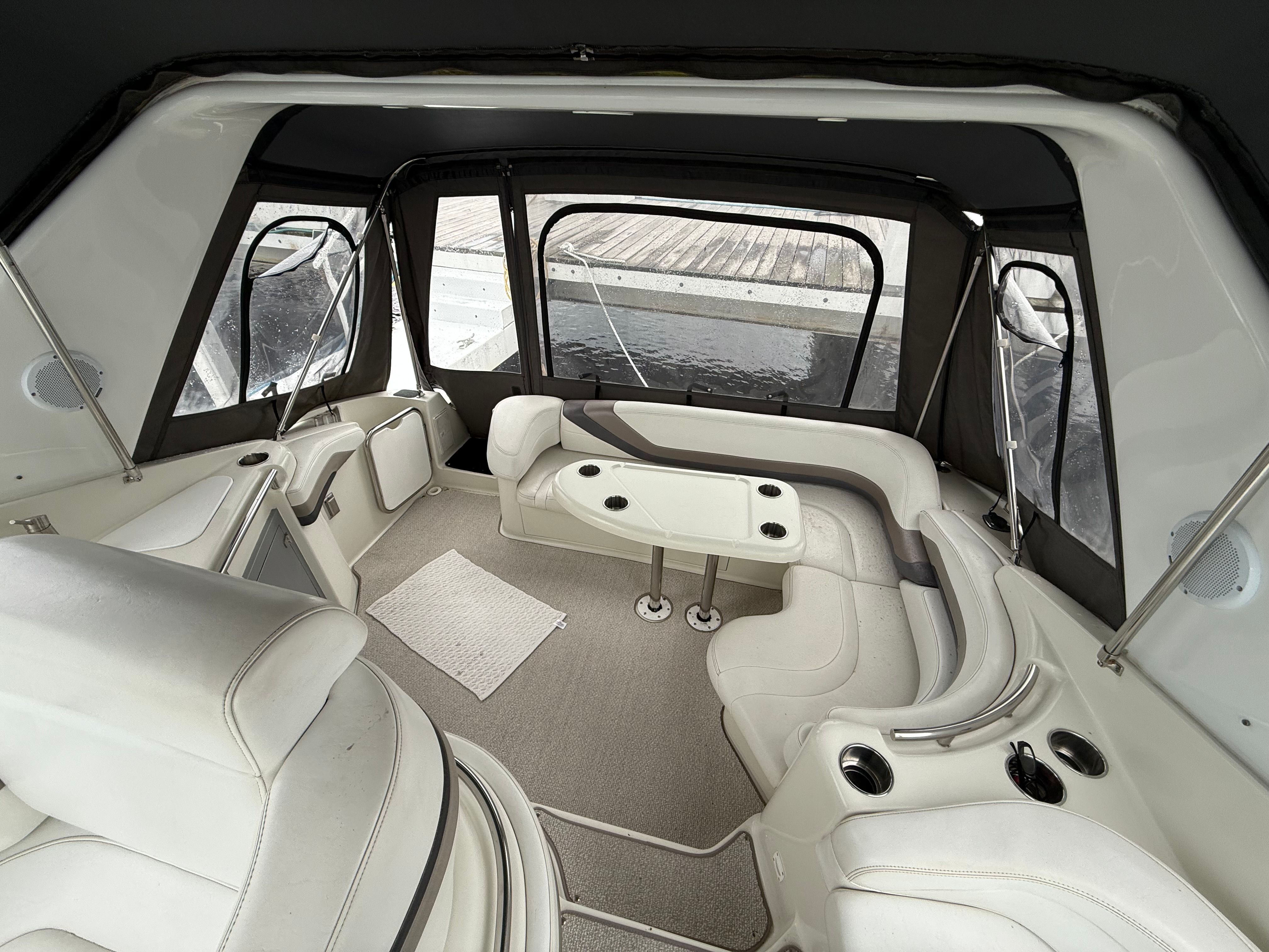 Interior of a 1995 Silverton 360 with white leather seating and a table.