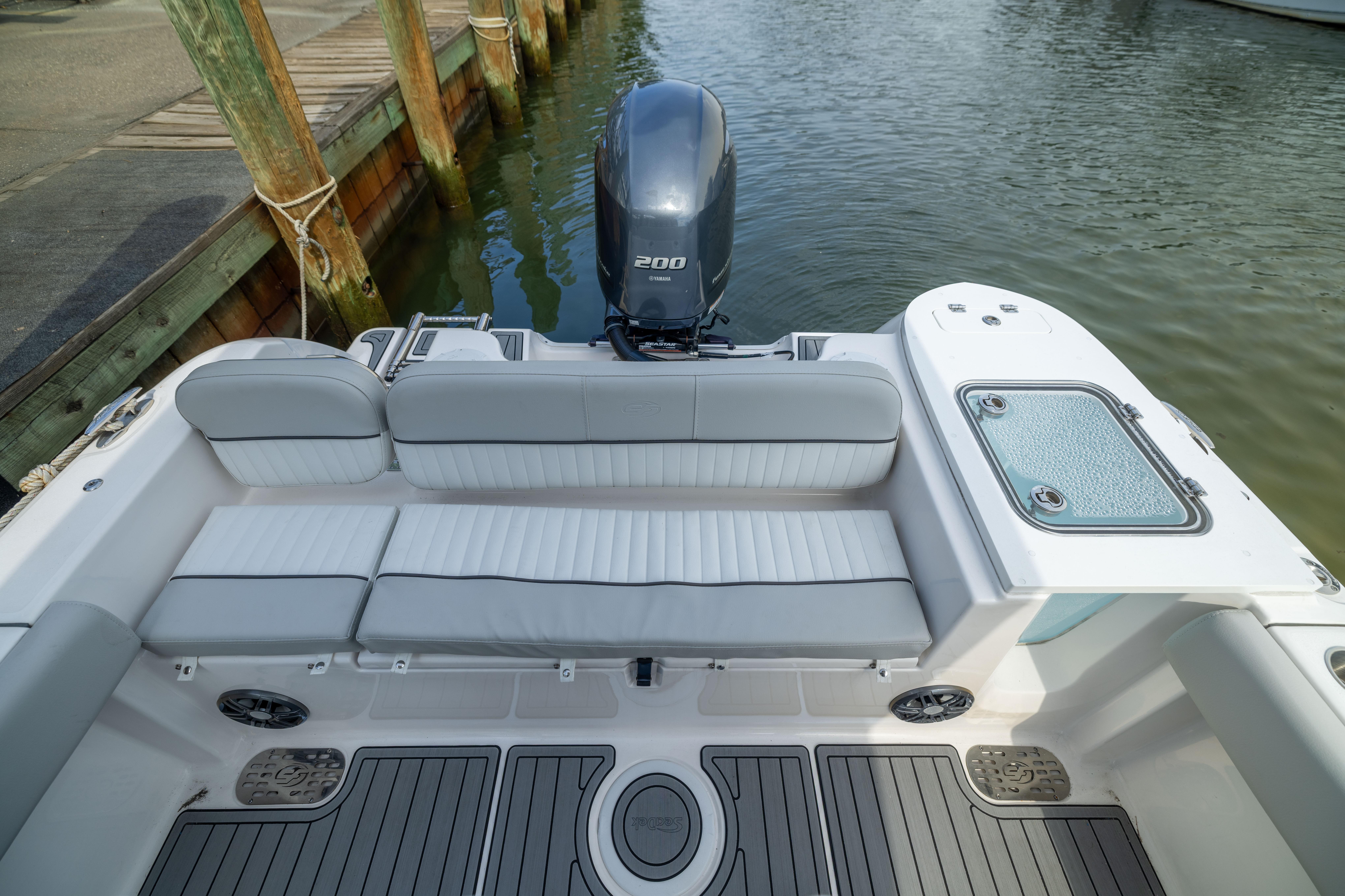 2023 Sea Fox 228 Commander boat interior with seating and outboard motor at dock.