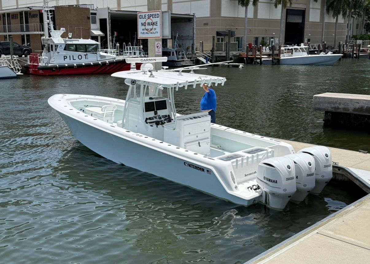 2019 Contender 35 ST boat docked with triple Yamaha engines.
