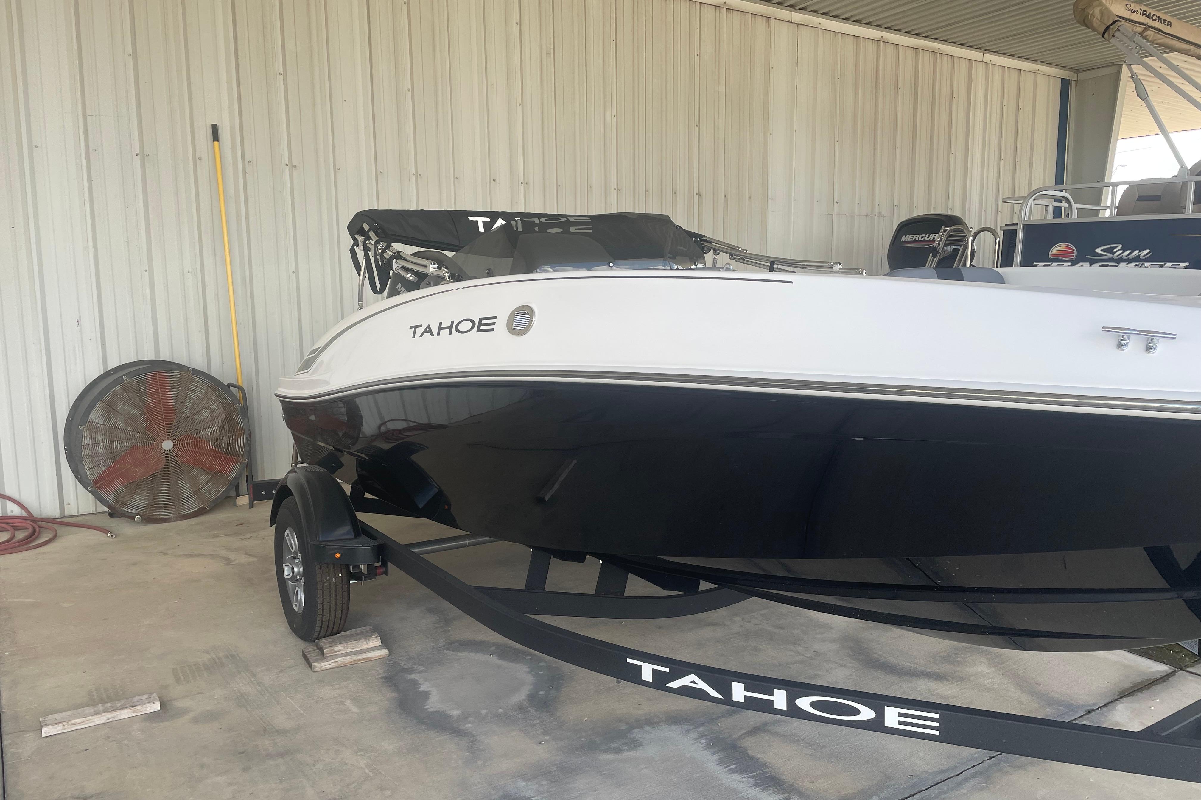 2026 Tahoe T16 boat on trailer in covered storage area.