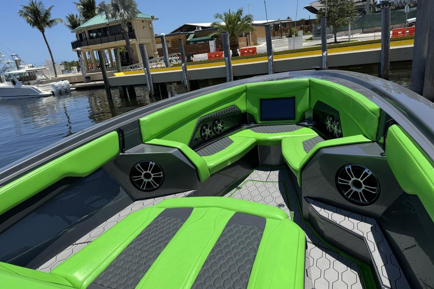 2023 Adrenaline 47 boat interior with vibrant green seating and modern design.