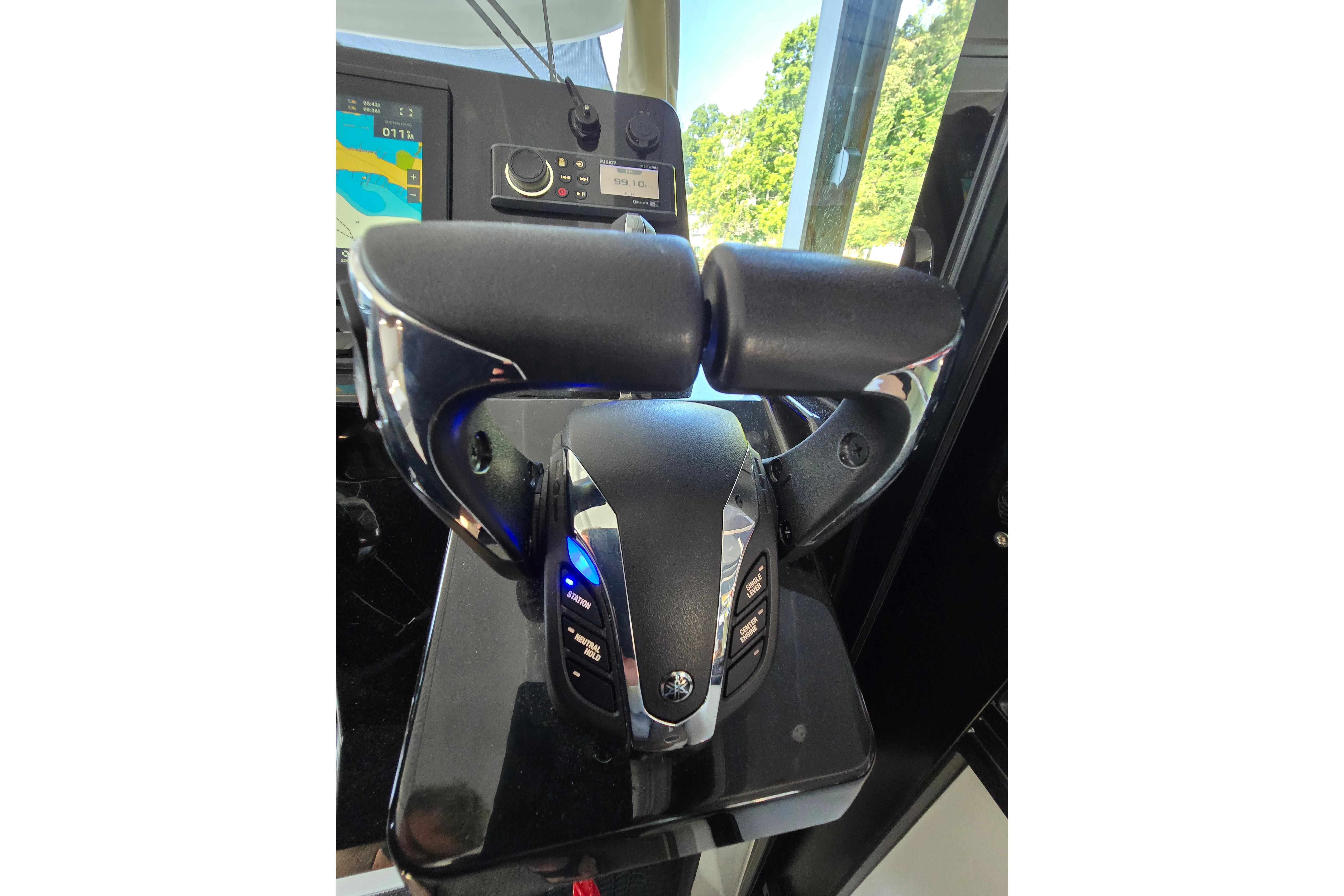 Close-up of the helm console on a Jeanneau NC Sport 895 with modern controls.