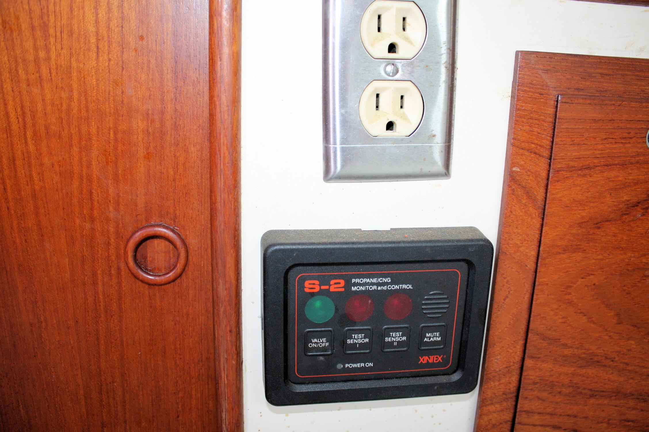 Control panel and electrical outlet on 1987 Ericson 38-200 yacht interior.
