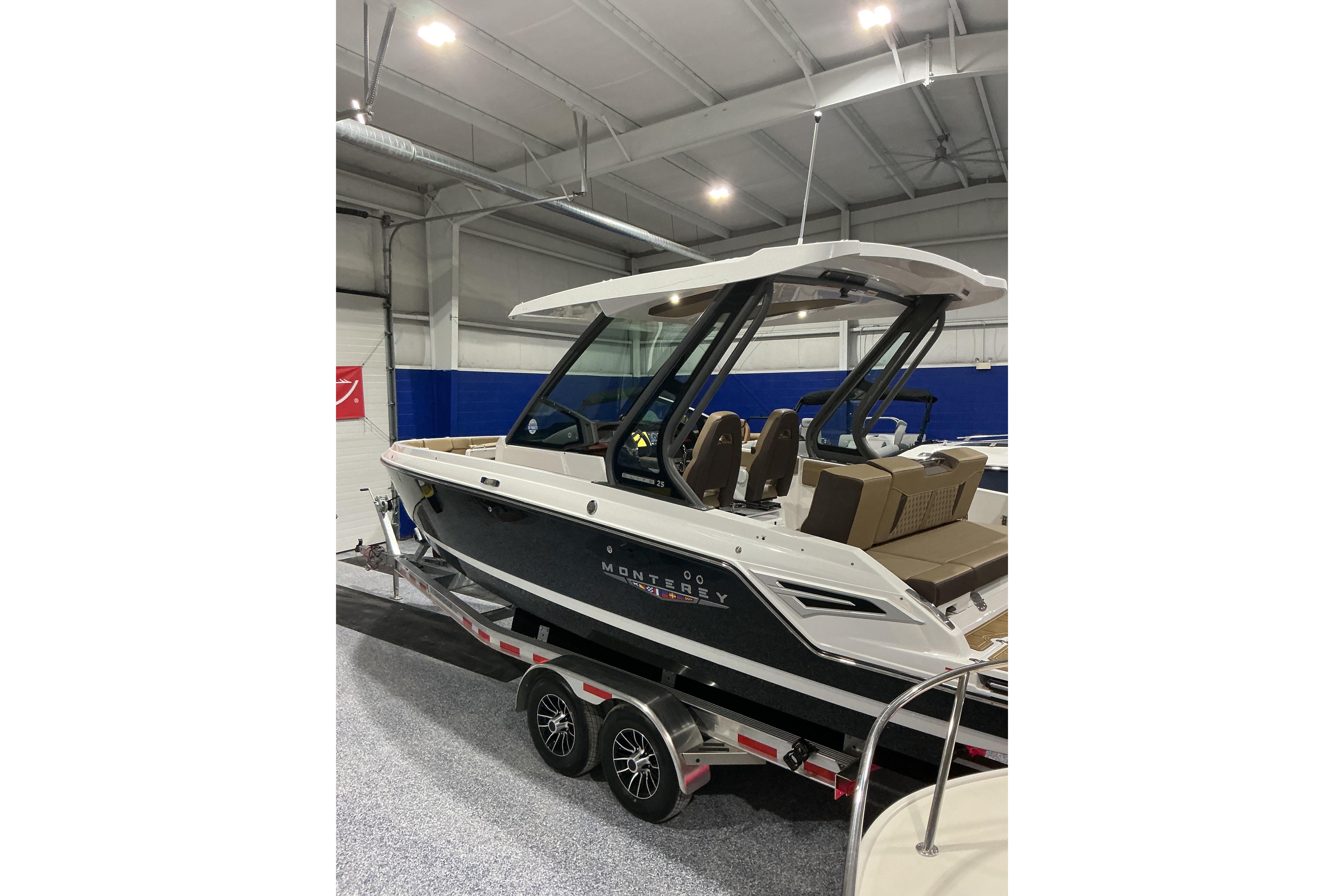 2026 Monterey Elite 25 SD boat displayed indoors on a trailer.