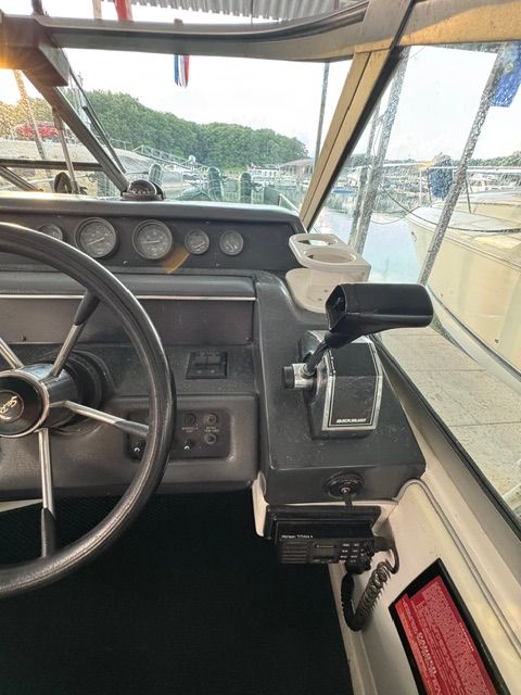 The cockpit of a 1992 Sea Ray 290 Sundancer showing the steering wheel and instrument panel.