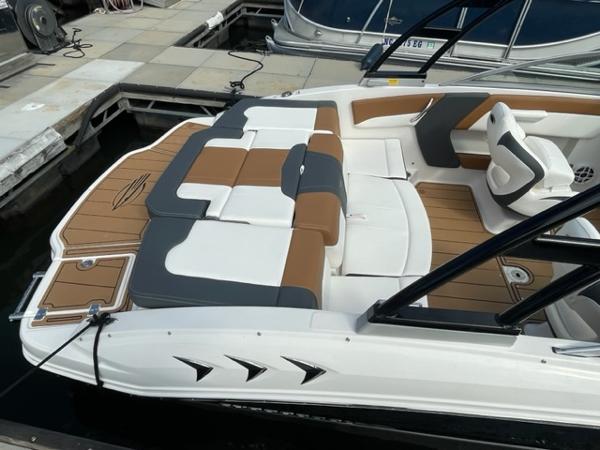 2025 Chaparral 21 SSi boat with stylish seating and modern design at a dock.