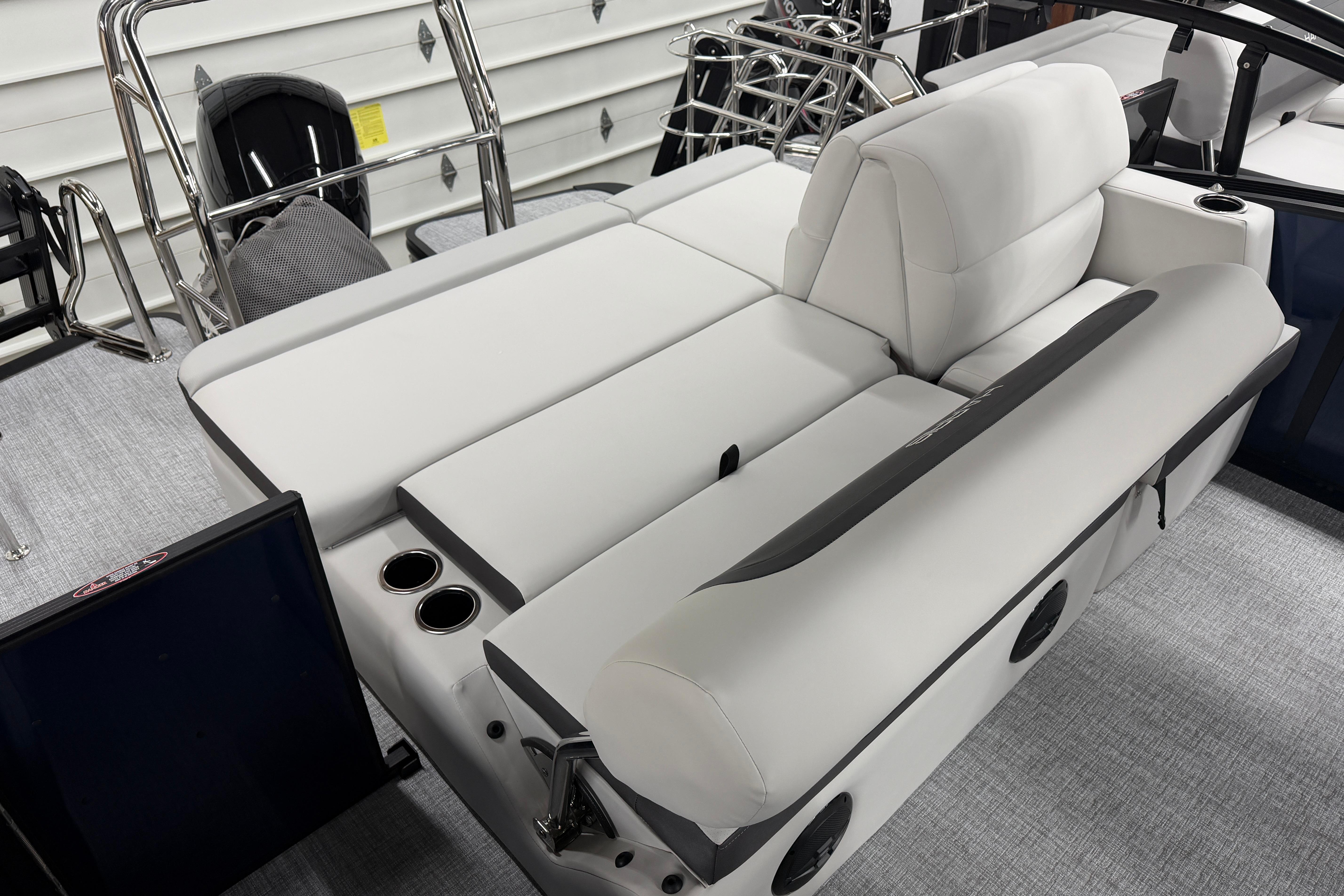 2026 Harris Cruiser 210 SLDH boat interior with plush seating and cup holders.