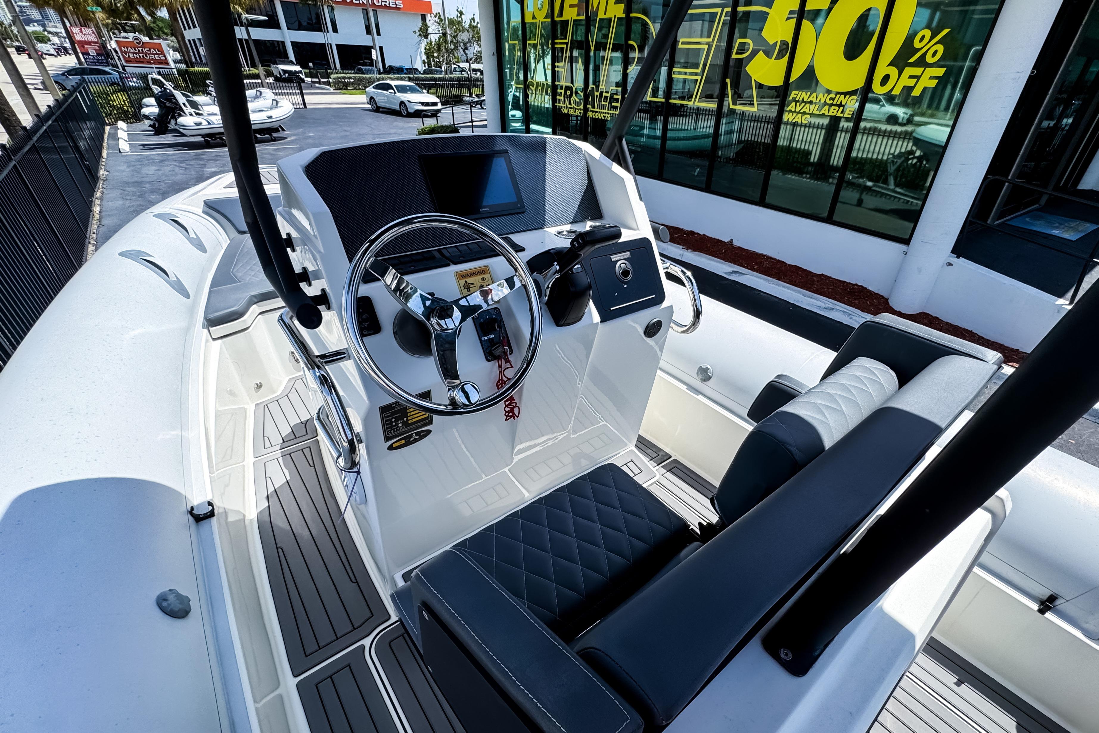 2022 Northstar Orion 7 boat interior with modern steering and seating, displayed at a dealership.