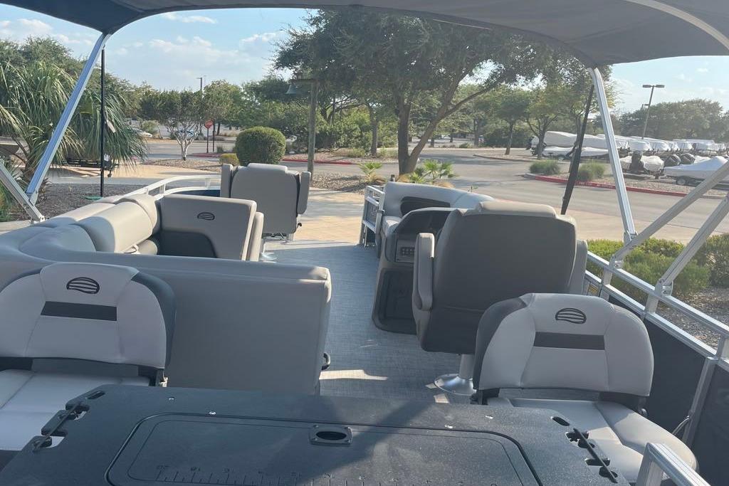 2026 Sun Tracker SportFish 20 DLX pontoon boat interior with seating and canopy.
