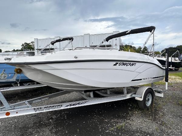 2024 Starcraft 171 SVX boat on trailer, white exterior, parked outdoors under cloudy sky.