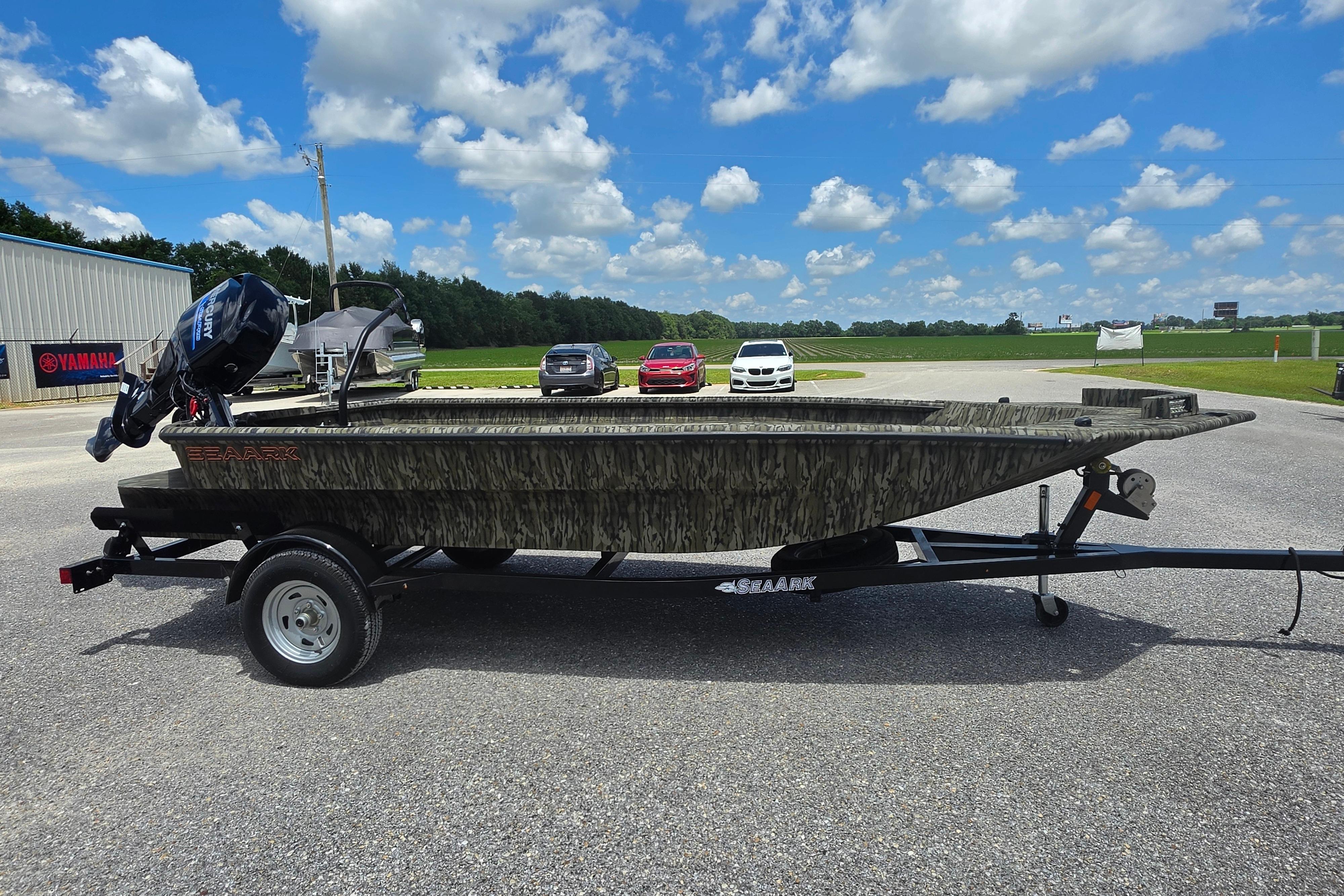 2025 SeaArk 1752 Slayer boat on trailer, parked outdoors under a blue sky.