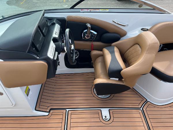 2024 Crownline Eclipse E255 boat interior with tan leather seating and wood-style flooring.