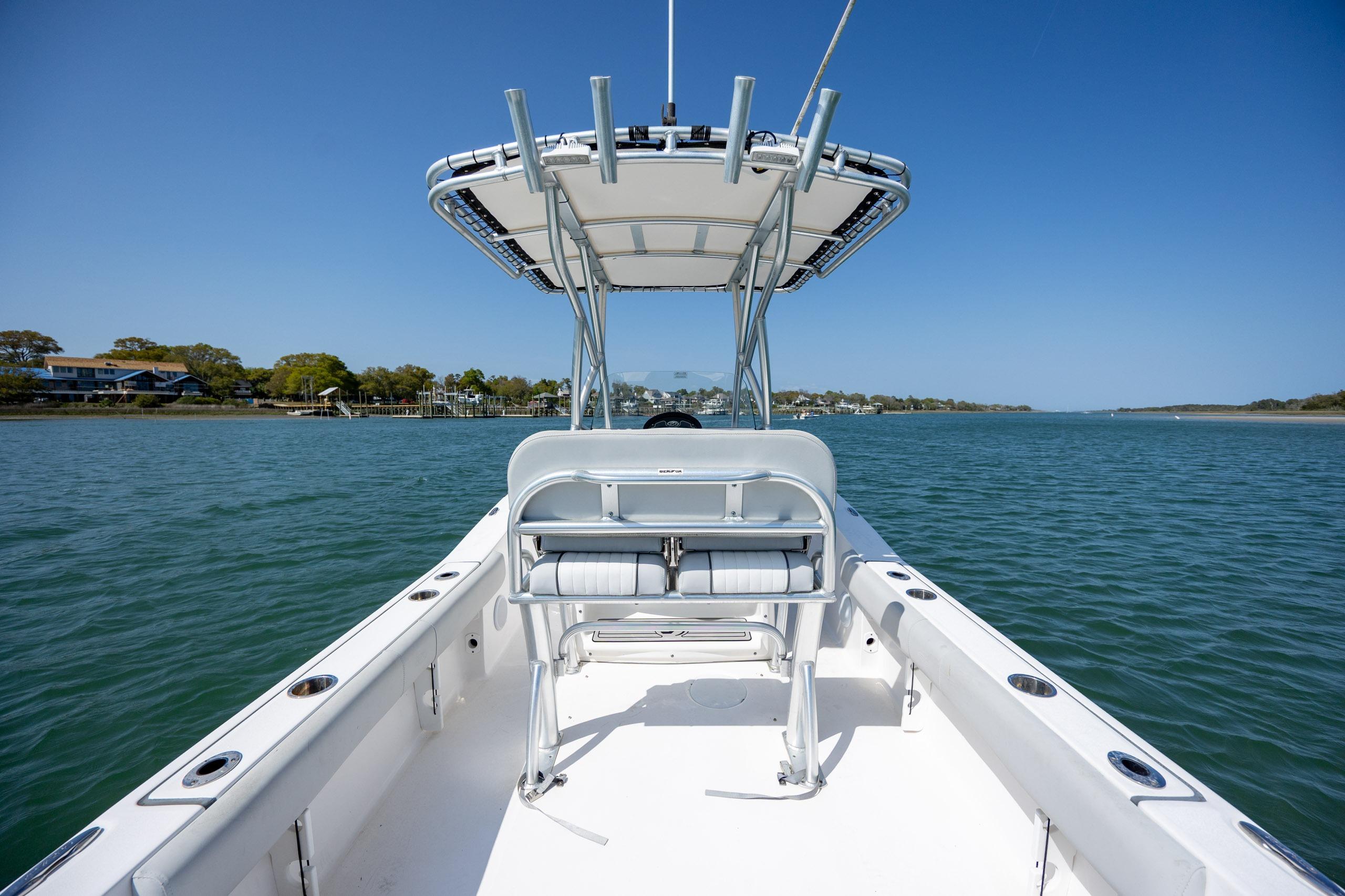 2020 Sea Fox 206 Commander boat on calm water under clear blue sky.