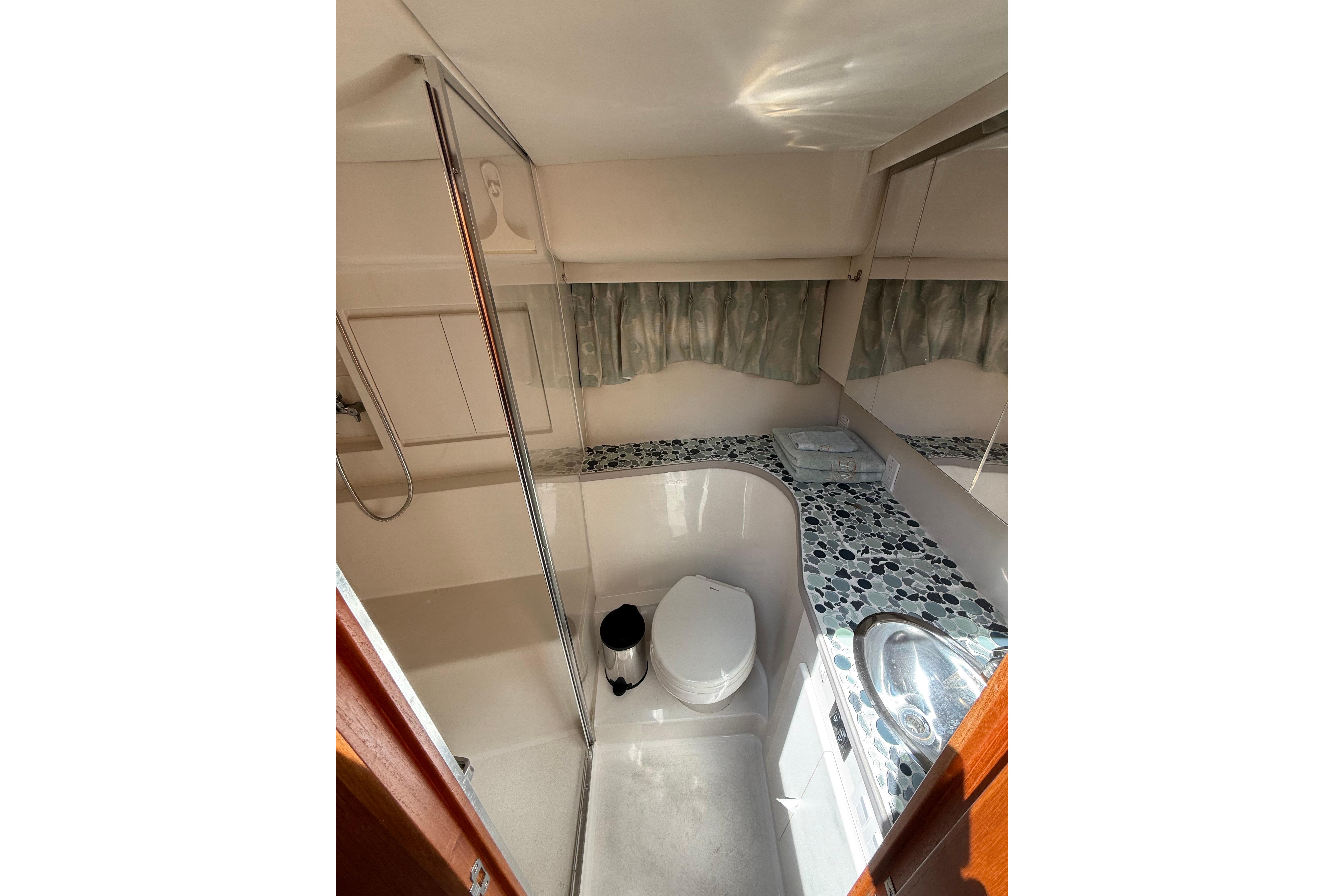 Bathroom interior of 1995 Carver 370 Voyager yacht with shower and sink.