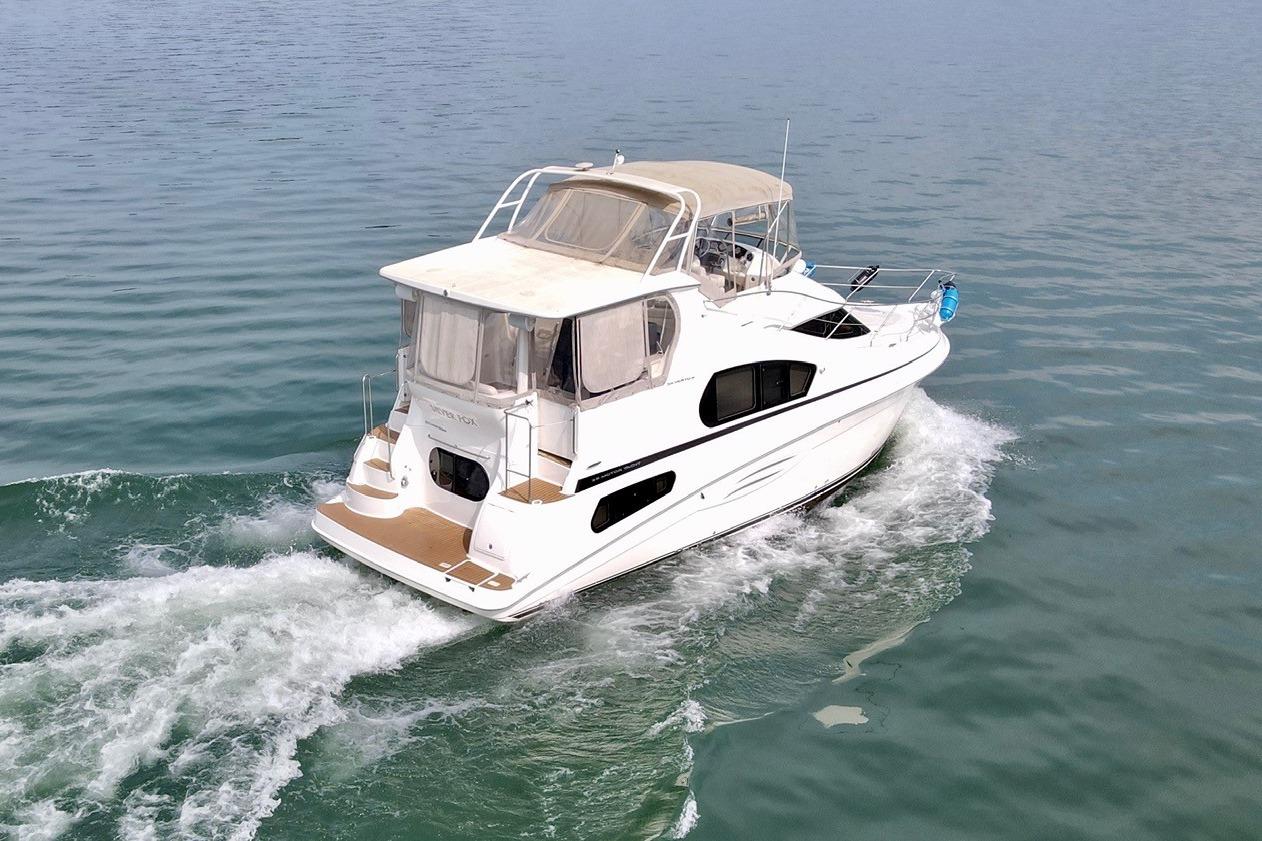 2004 Silverton 39 Motor Yacht cruising on calm waters.