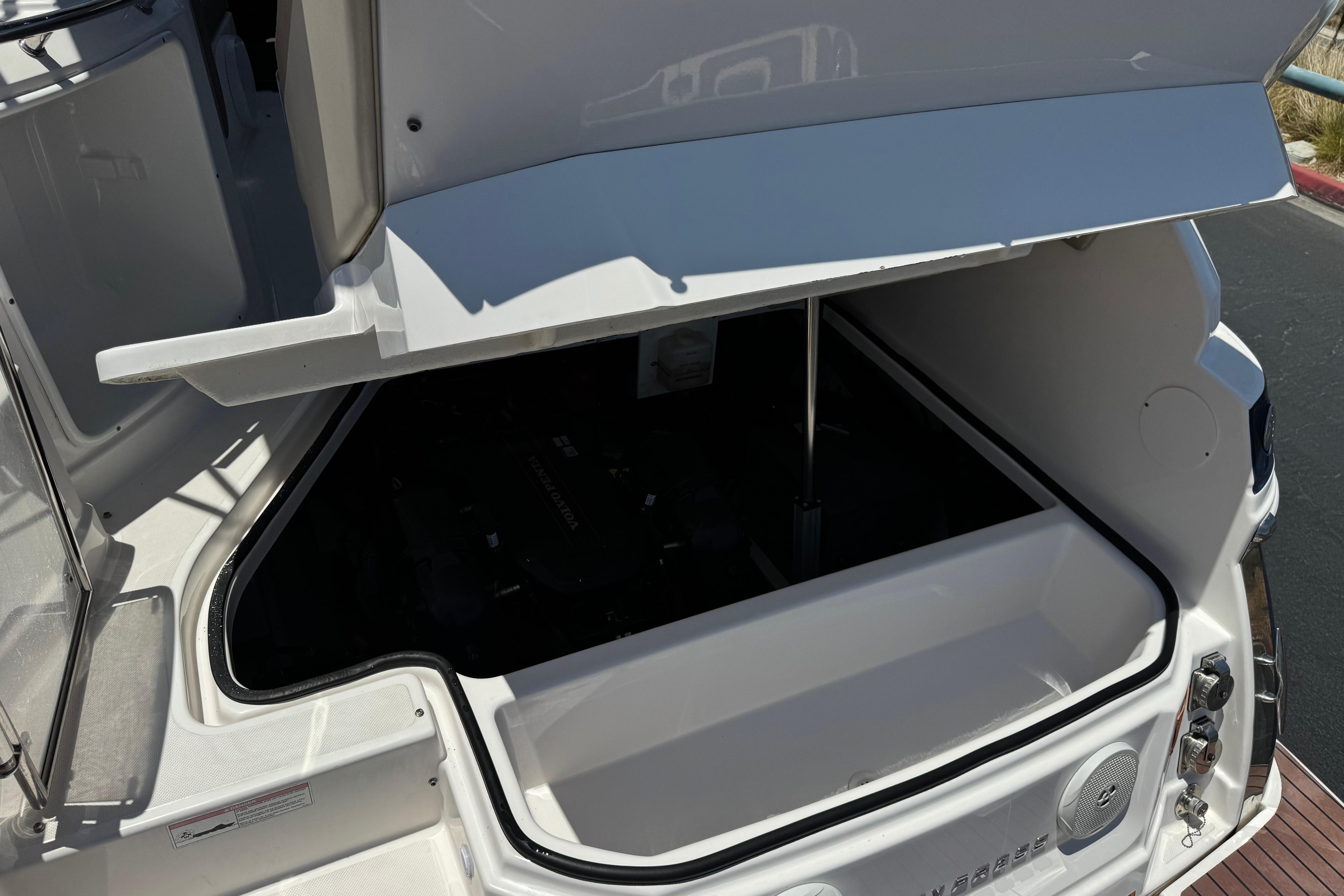 Open storage compartment on a 2013 Regal 28 Express boat, showcasing interior space.