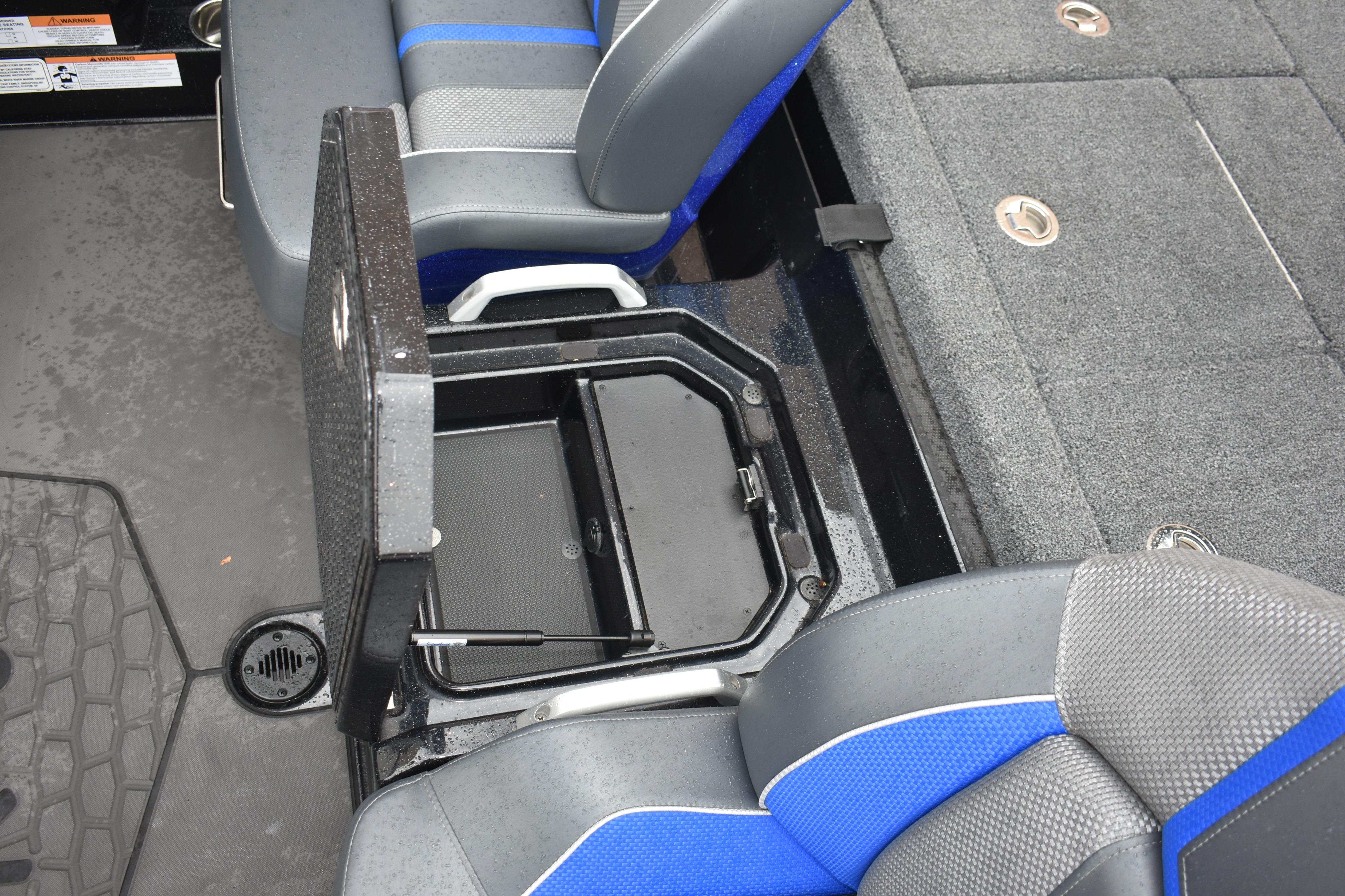 2025 Ranger Z521 boat interior with open storage compartment and blue-gray seating.