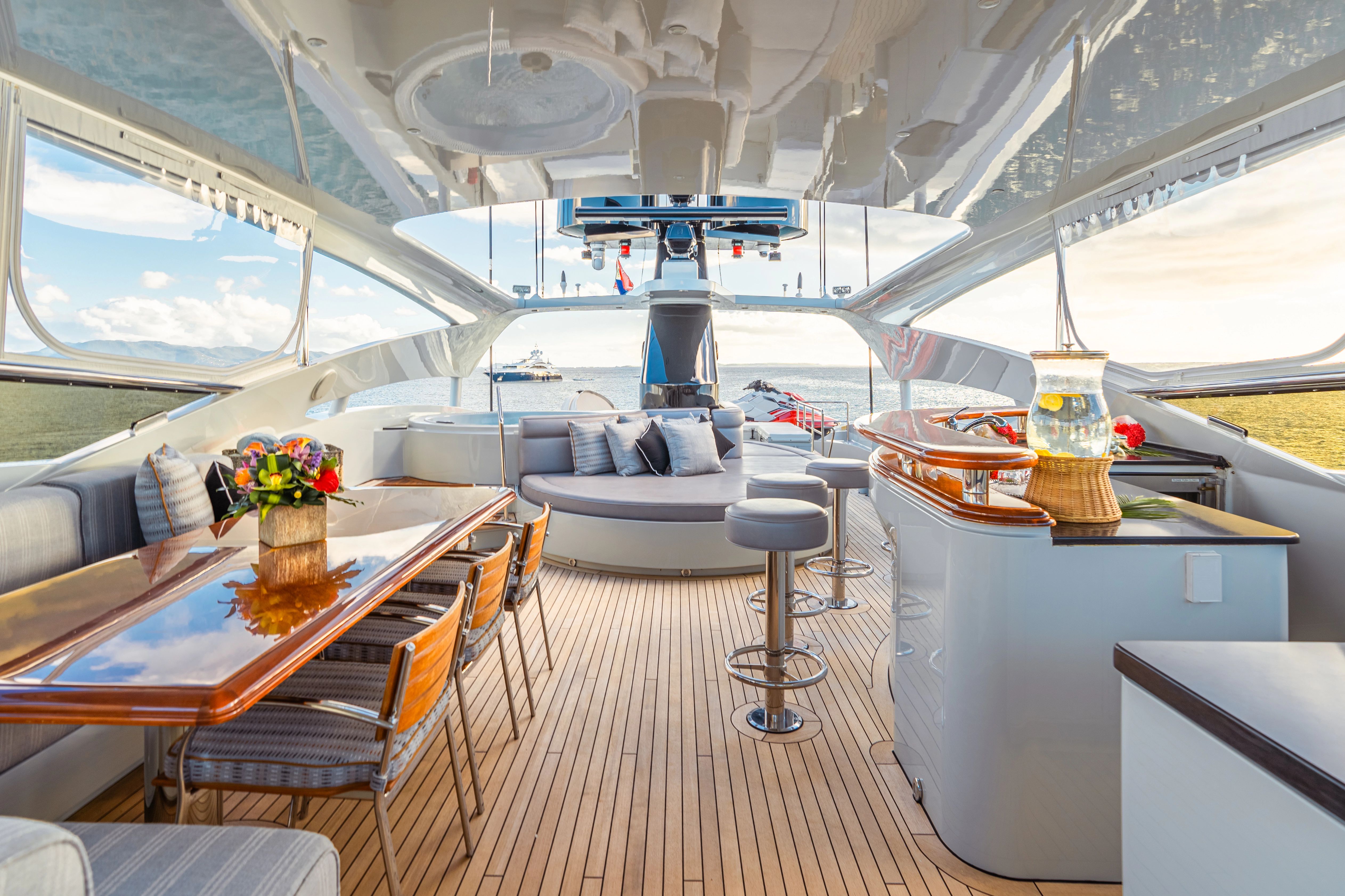 Luxurious salon of a 2005 Palmer Johnson Raised Pilothouse yacht with elegant furnishings.