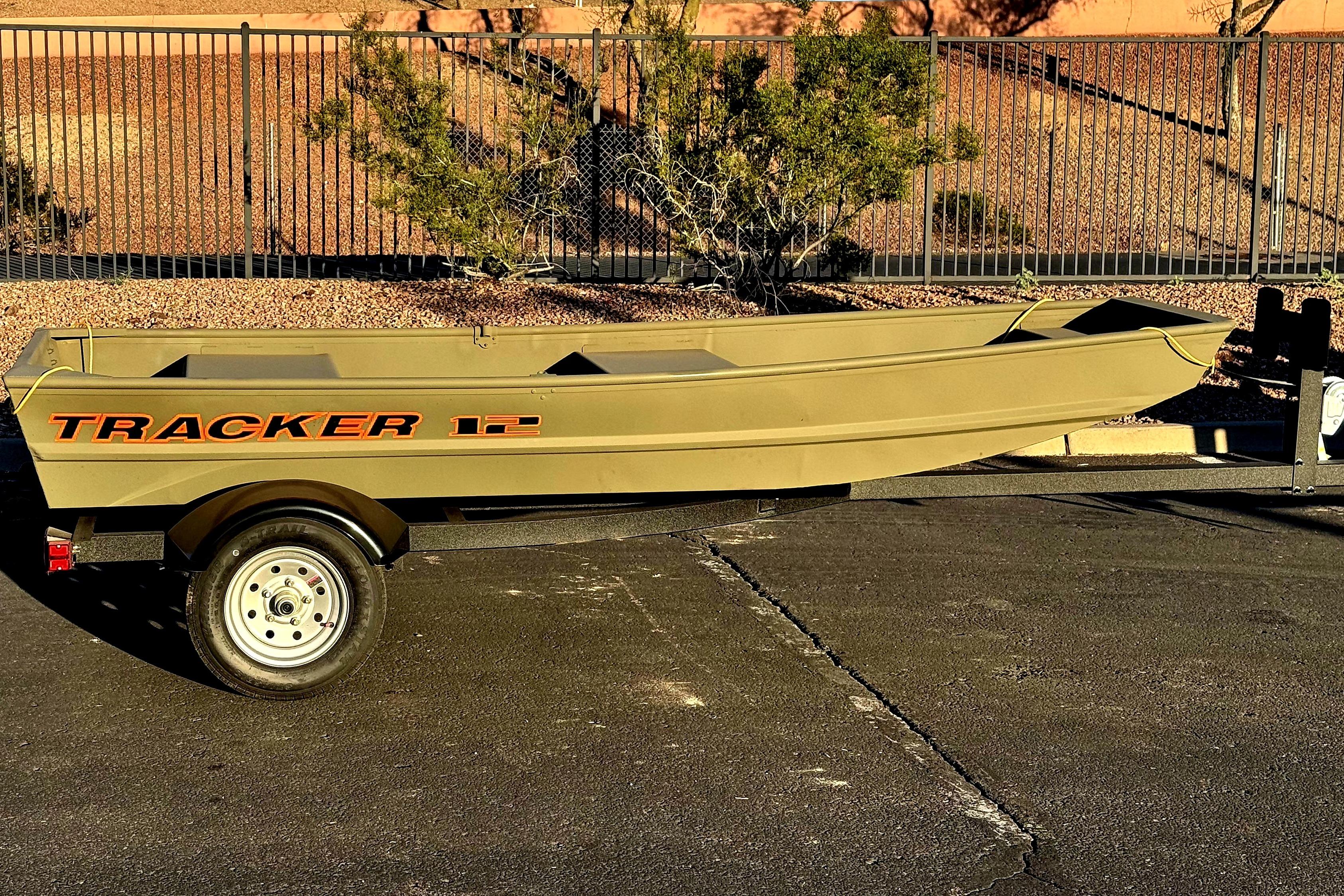 2026 Tracker Grizzly 12 Jon boat on trailer, parked outdoors.