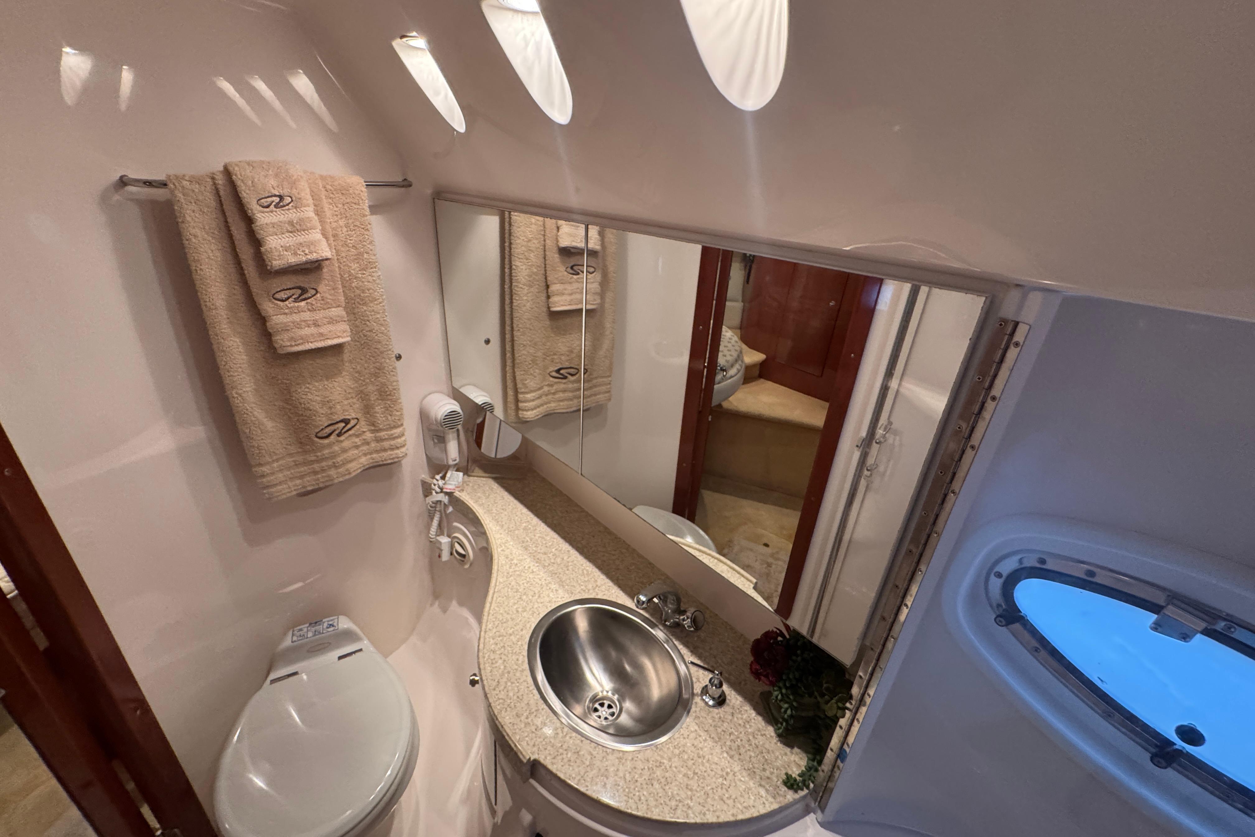 Luxurious bathroom in 2005 Regal Commodore 4260 yacht with modern fixtures and elegant design.