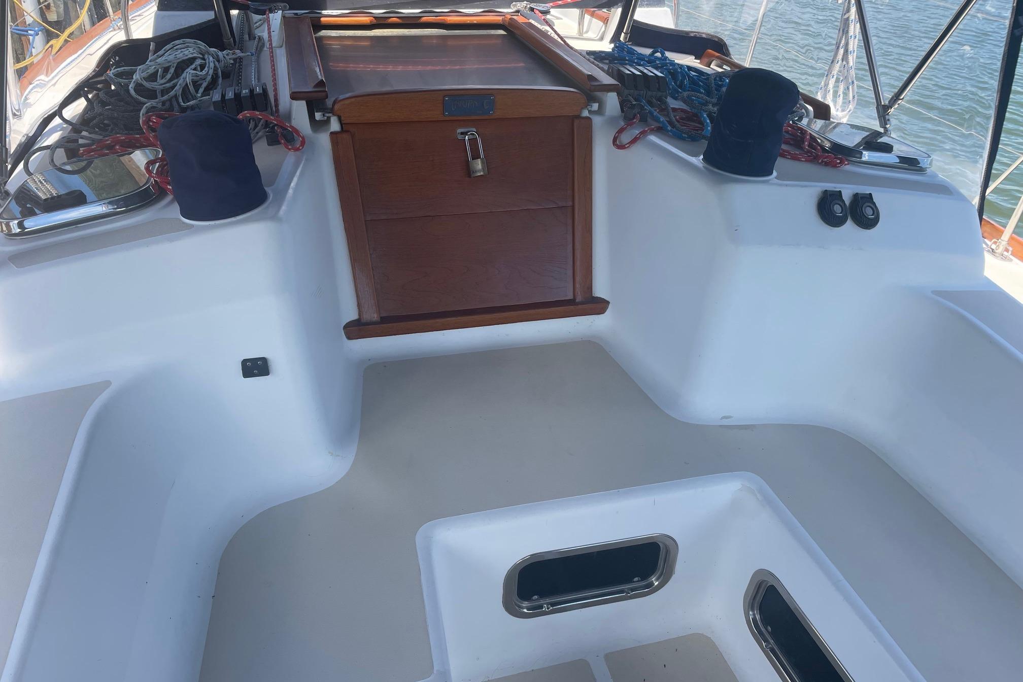 Cockpit of 2001 Tartan 3700 sailboat with ropes and wooden hatch.