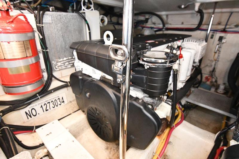 Engine room of 2008 Carver 43 Super Sport with visible fire extinguisher and engine components.