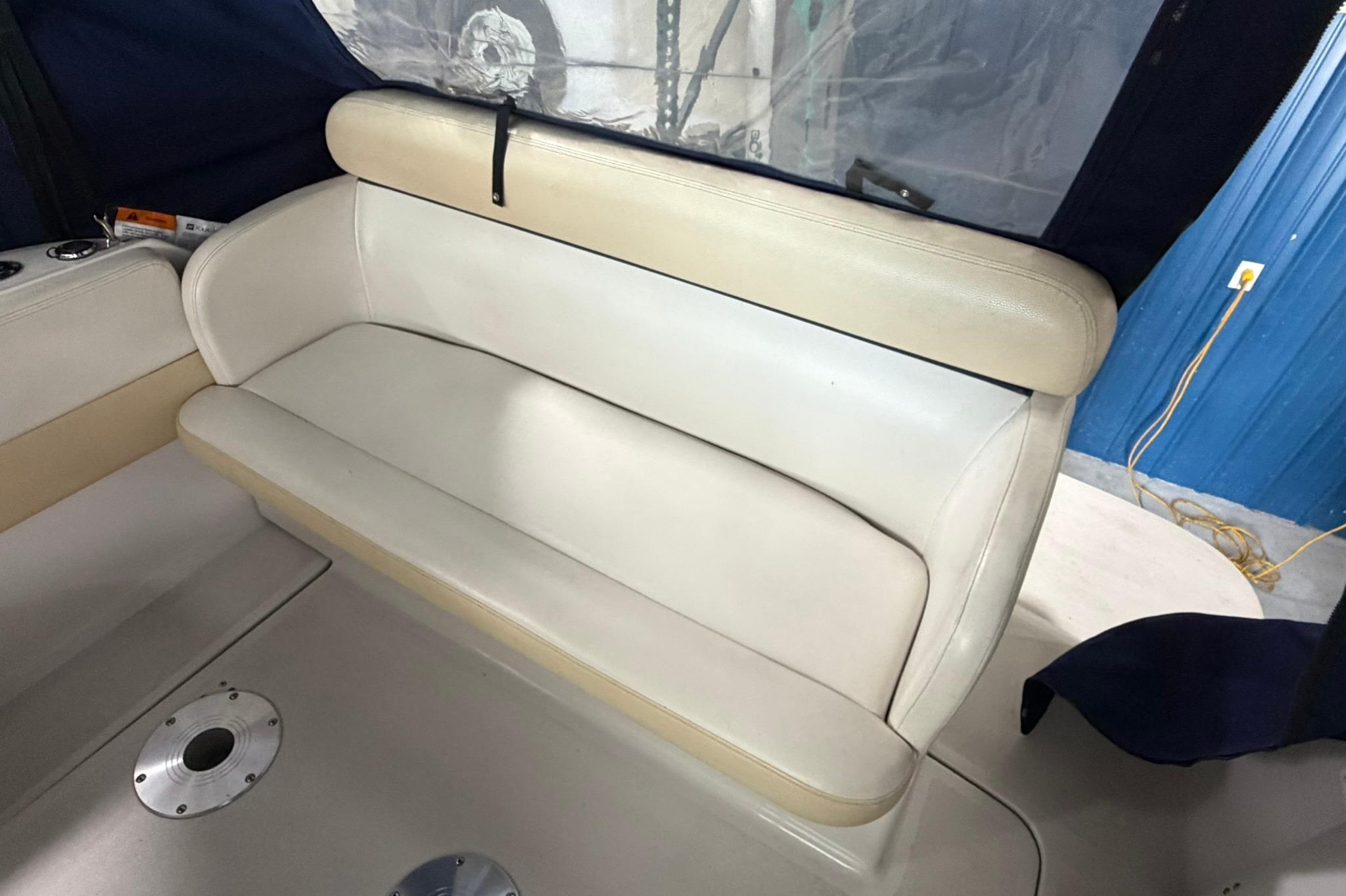 2008 Four Winns V248 boat interior with beige seating and blue canopy.