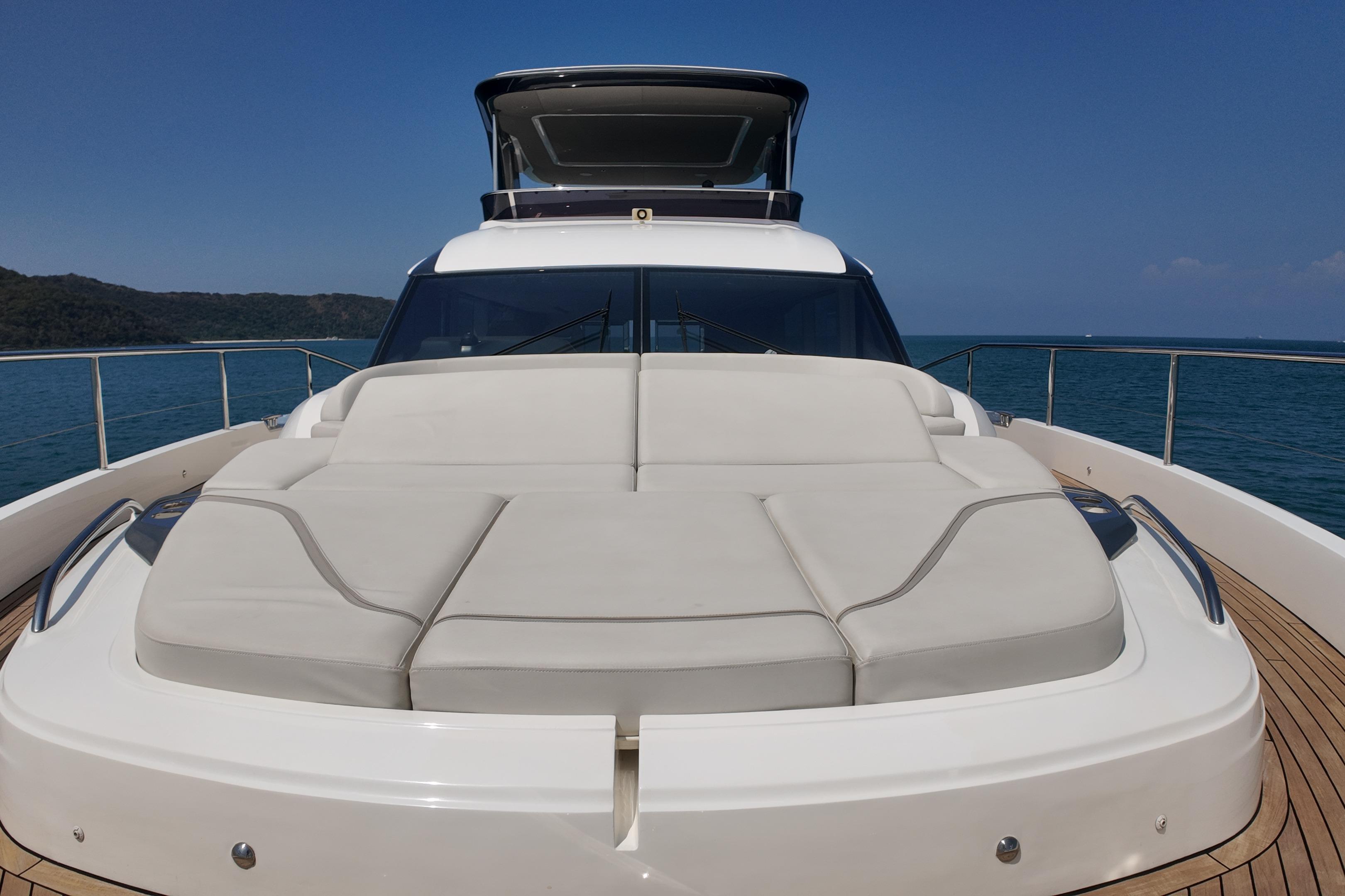 2023 Princess Y72 yacht with spacious sunbed on deck, cruising in serene waters.