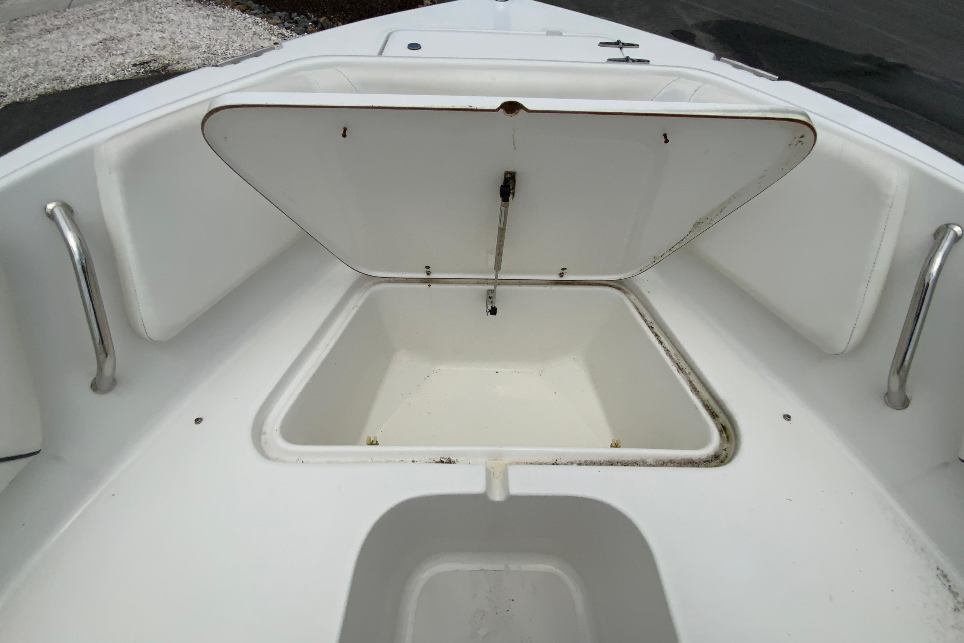 2014 Sea Hunt Escape 211 LE boat storage compartment open, showcasing interior space.