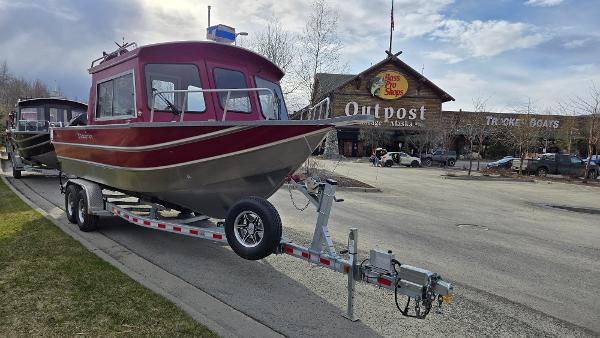 2024 Spartan 24 MAXIMUS PRO XL boat on trailer outside outdoor store.