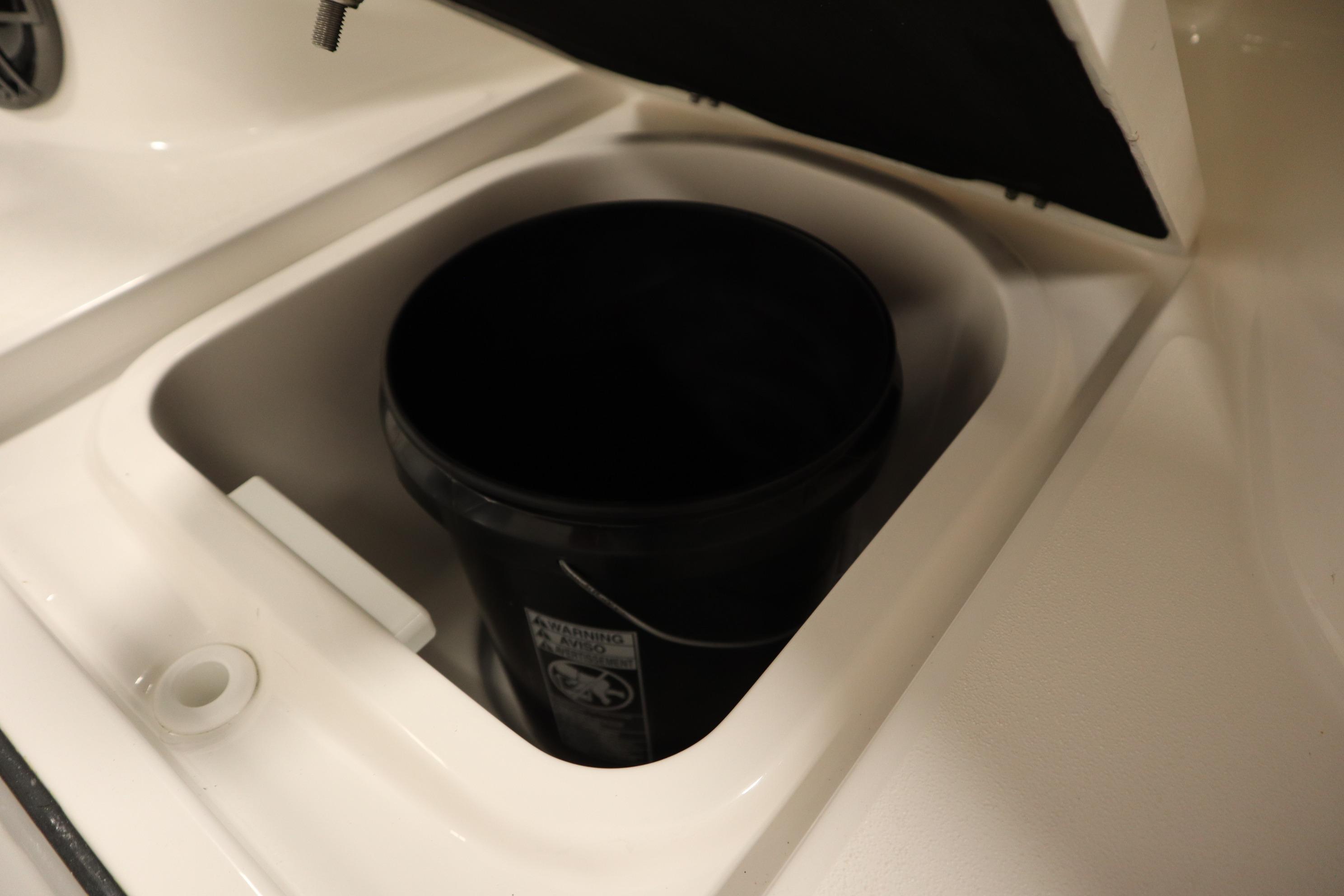 Storage compartment with black bucket in 2026 Sea Fox 228 Commander boat.